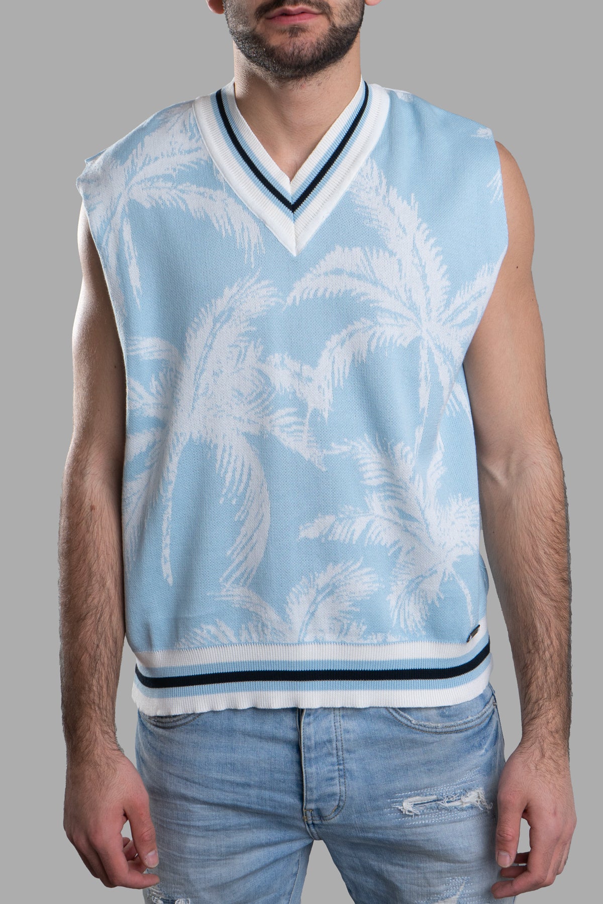 Gaëlle Paris Knit Vest with V-neckline, sleeveless design, featuring a blue palm print, shown on a model from the front.