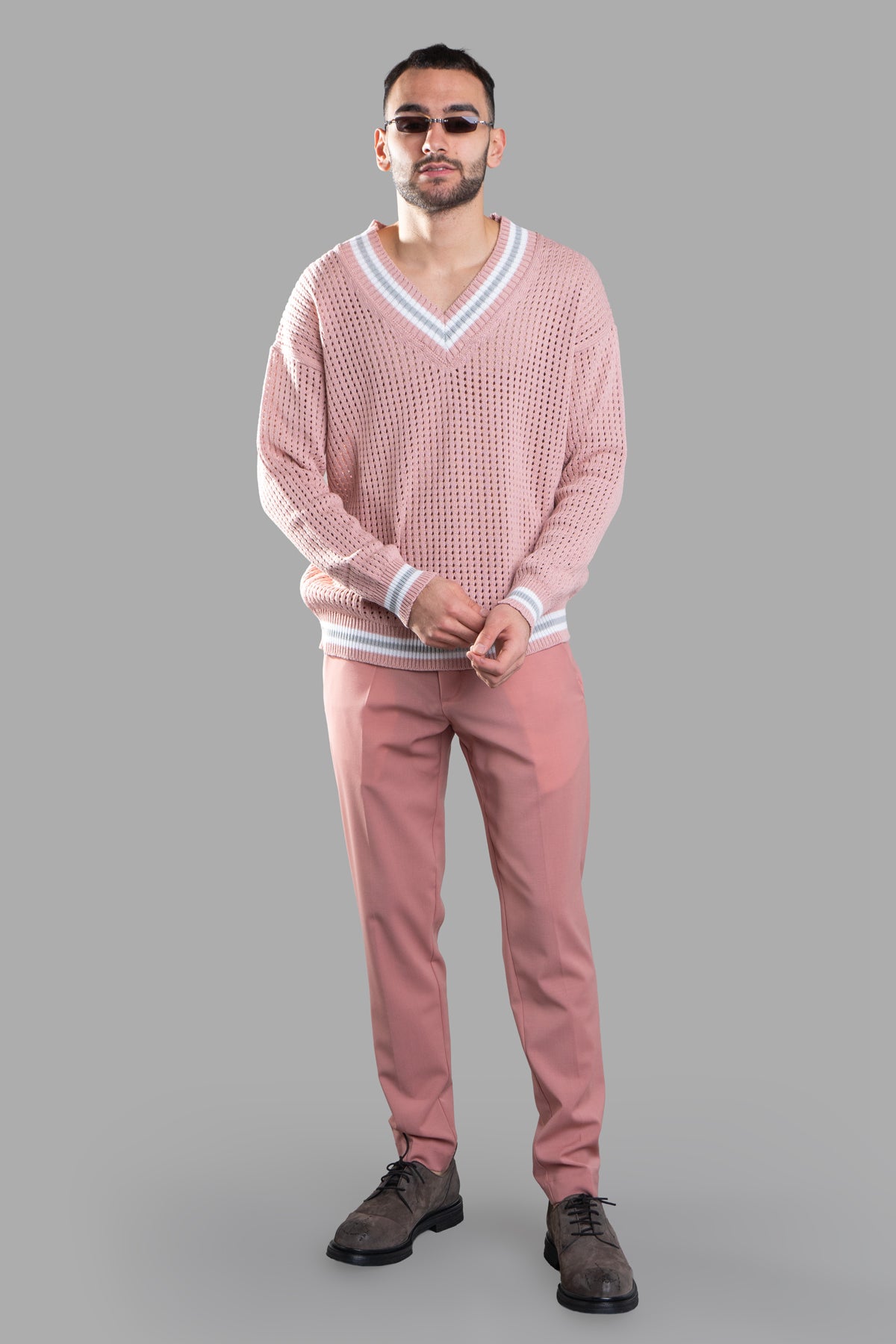 Gaëlle Paris pink straight-leg trousers, front view on model, featuring center crease, side and back pockets, and belt loops.
