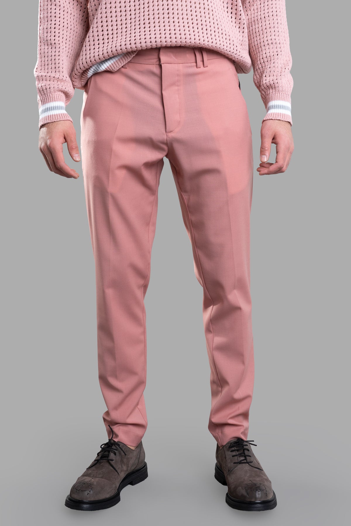 Gaëlle Paris Straight-leg Trousers in pink, featuring a sharp center crease and pockets, styled with a knit sweater.