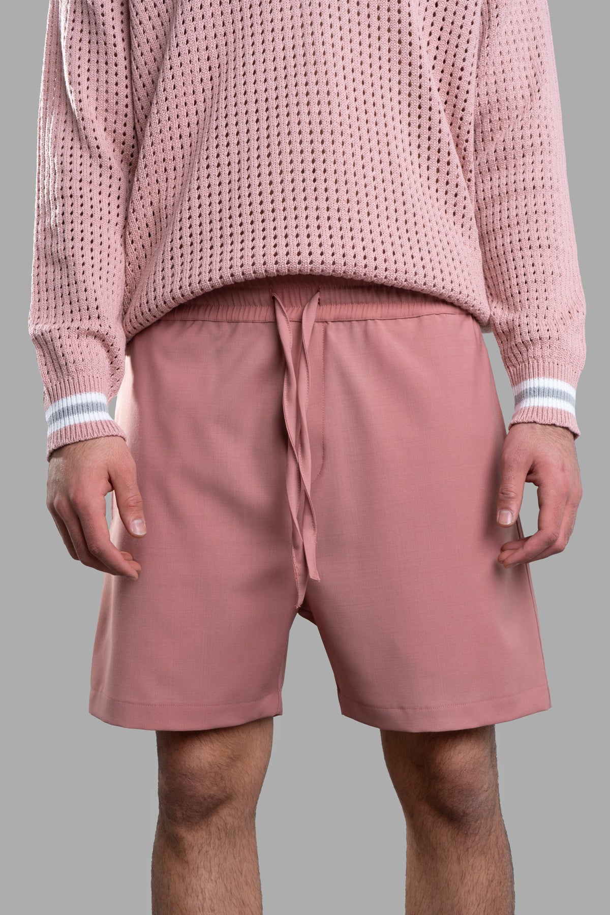 Gaëlle Paris Pink Bermuda Shorts featuring an elasticated waistband and drawstrings, shown from the front on-model.