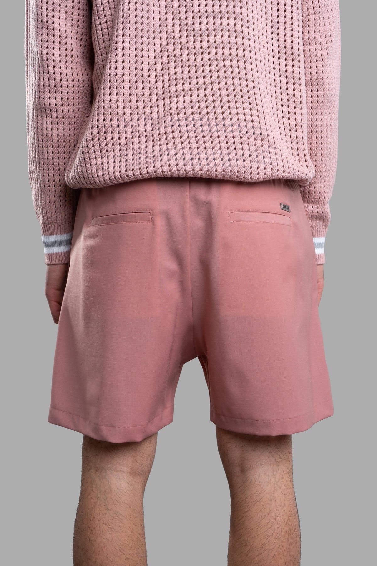 Gaëlle Paris Pink Bermuda Shorts, shown from behind, featuring an elasticated waistband and side pockets in soft fabric.