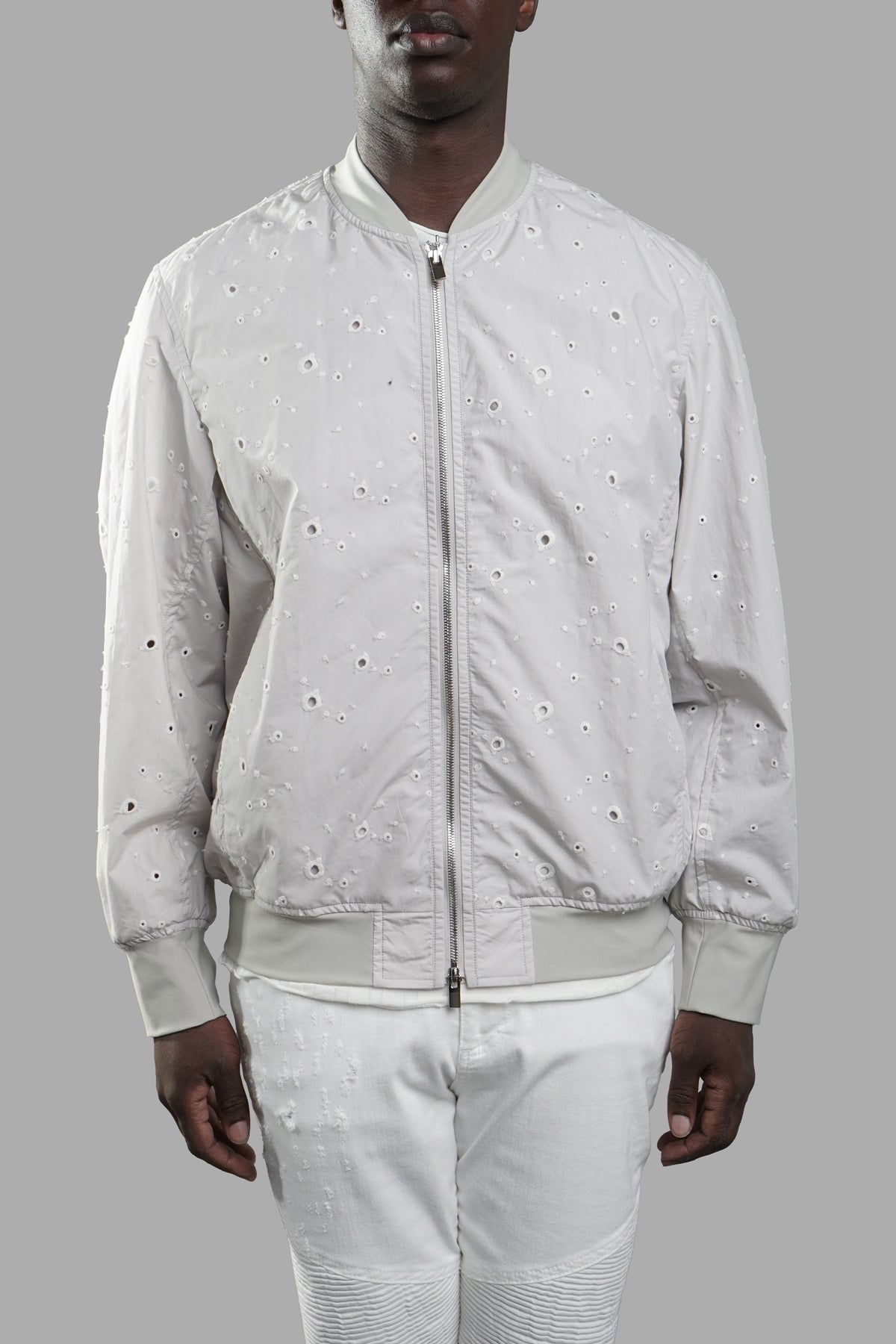Vein Lightweight Bomber Jacket in light grey, featuring unique hole details, modeled from the front for a stylish look.