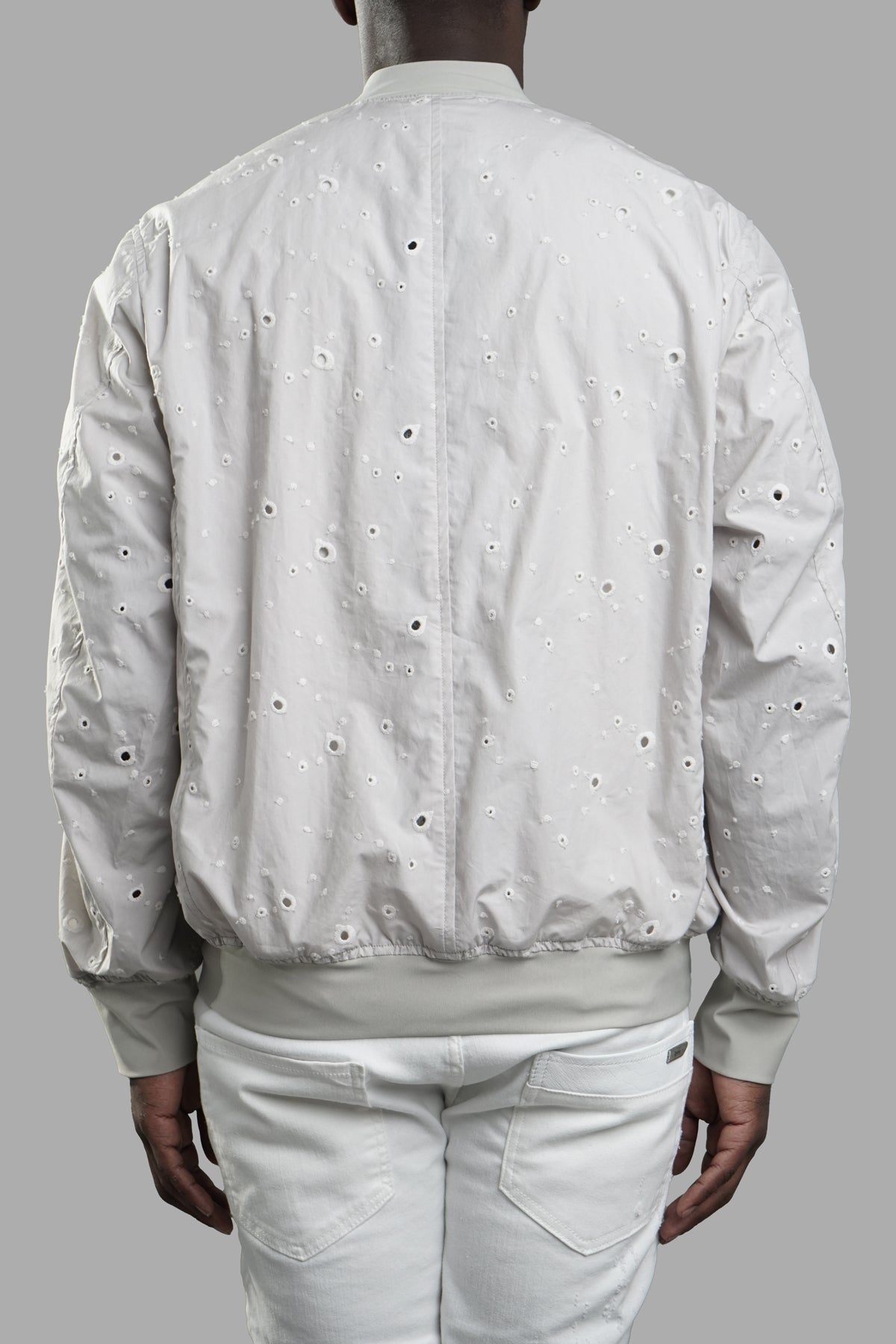 Vein Lightweight Bomber Jacket in light grey, showcasing detailed back design with unique perforations and ribbed hem.