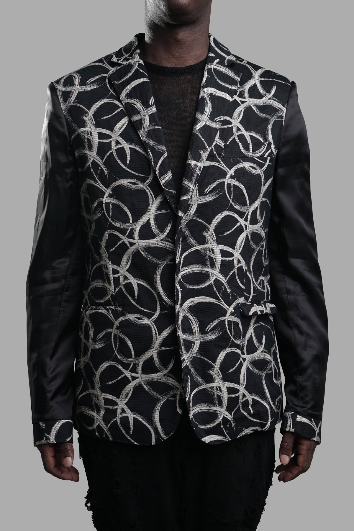 Giovanni Cavagna Graphic-print Blazer showcased with a modern oversized fit, black sleeves, and artistic details.