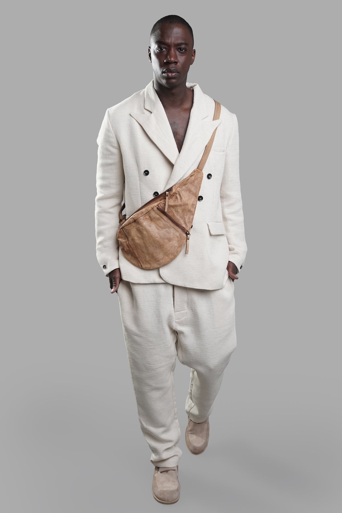 Marc Point Double-breasted Blazer in white with wide lapels, front view on-model, paired with tan crossbody bag.