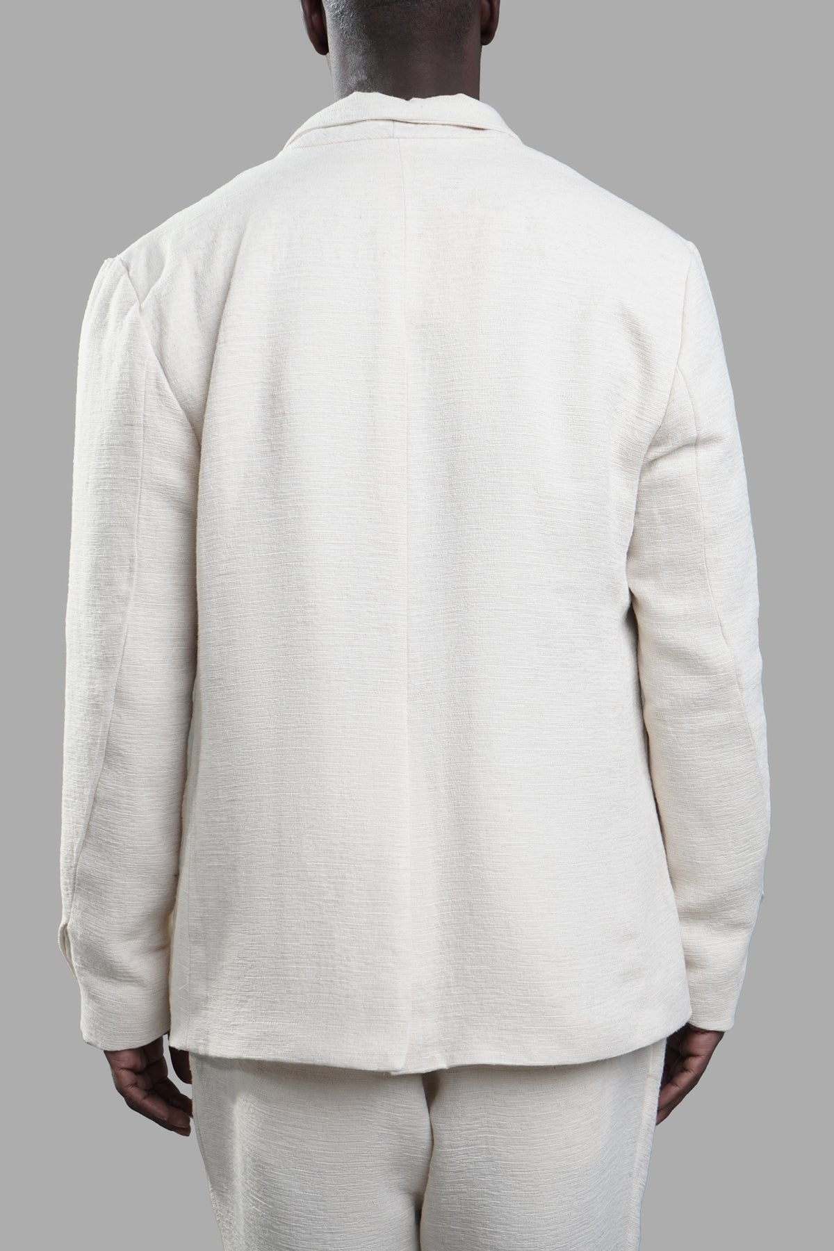 Marc Point Double-breasted Blazer, back view showcasing wide peaked lapels and textured white linen fabric.