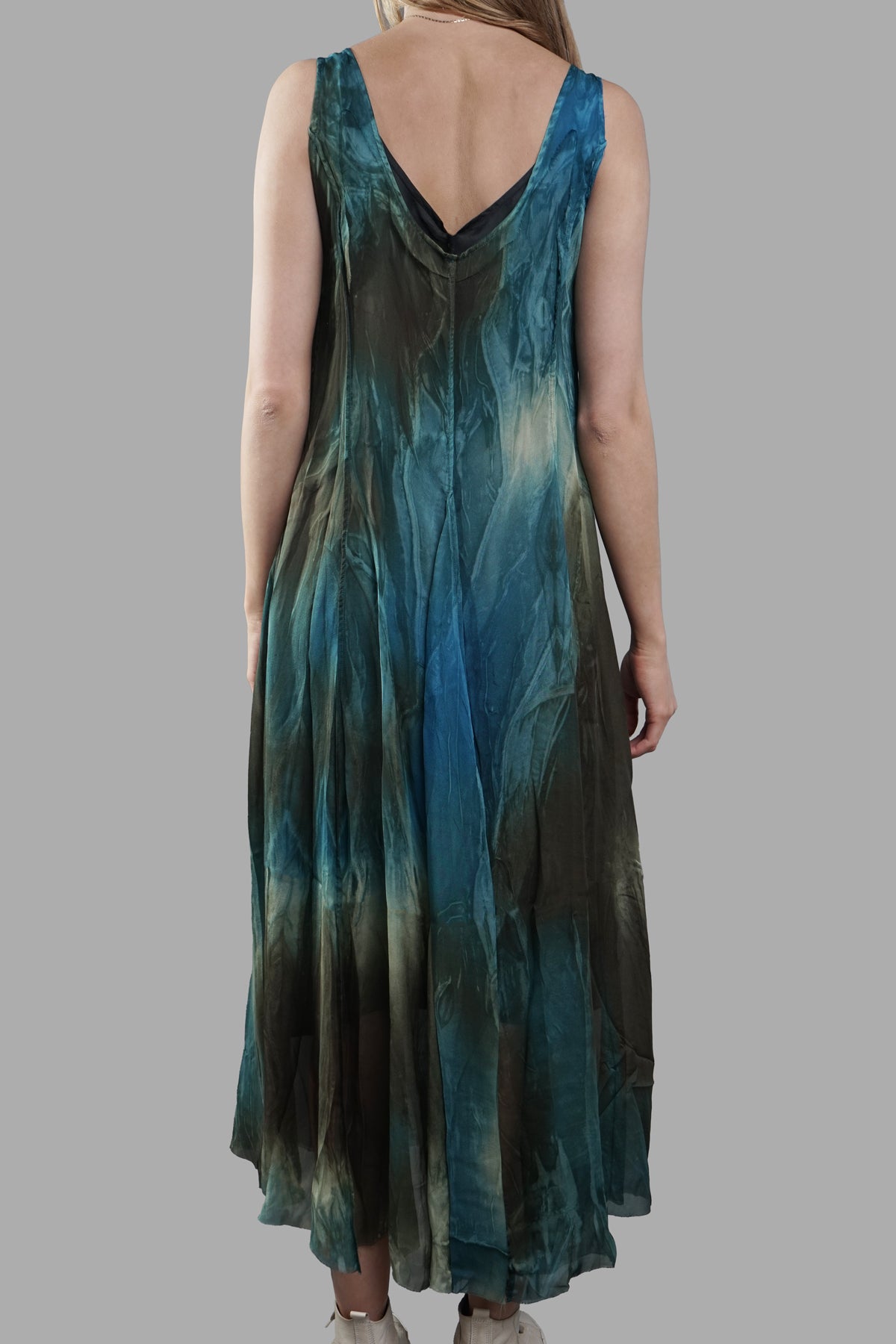 Masnada Abstract-print Dress on-model back view, sleeveless V-back maxi in teal/green tones with flowing hem.