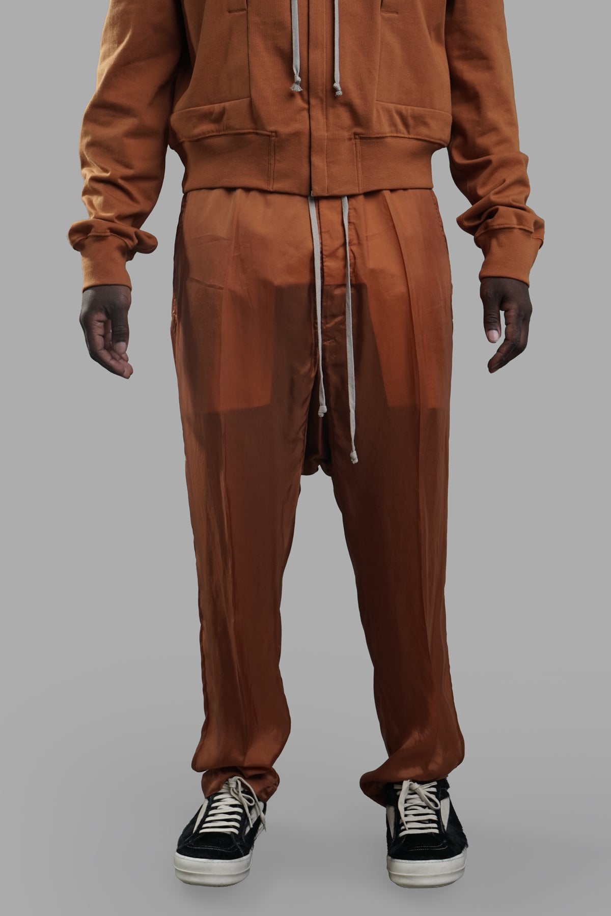 Rick Owens Silk Drop-crotch Trousers in orange, featuring an elasticized waistband and front creases, showcased on model.