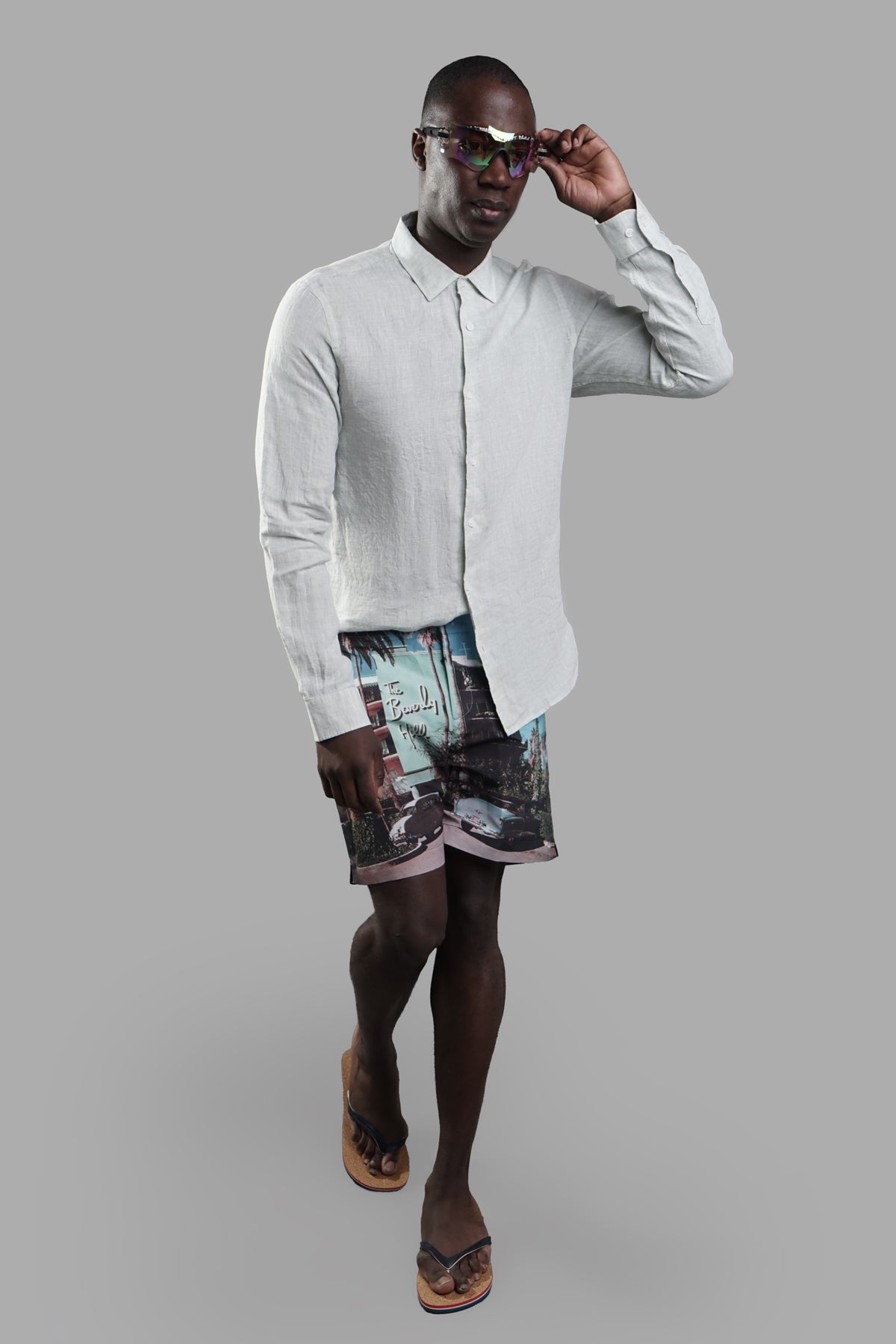 Orlebar Brown Beverly Hills Swim Shorts on-model, front view with a printed design, paired with a light shirt and sunglasses.