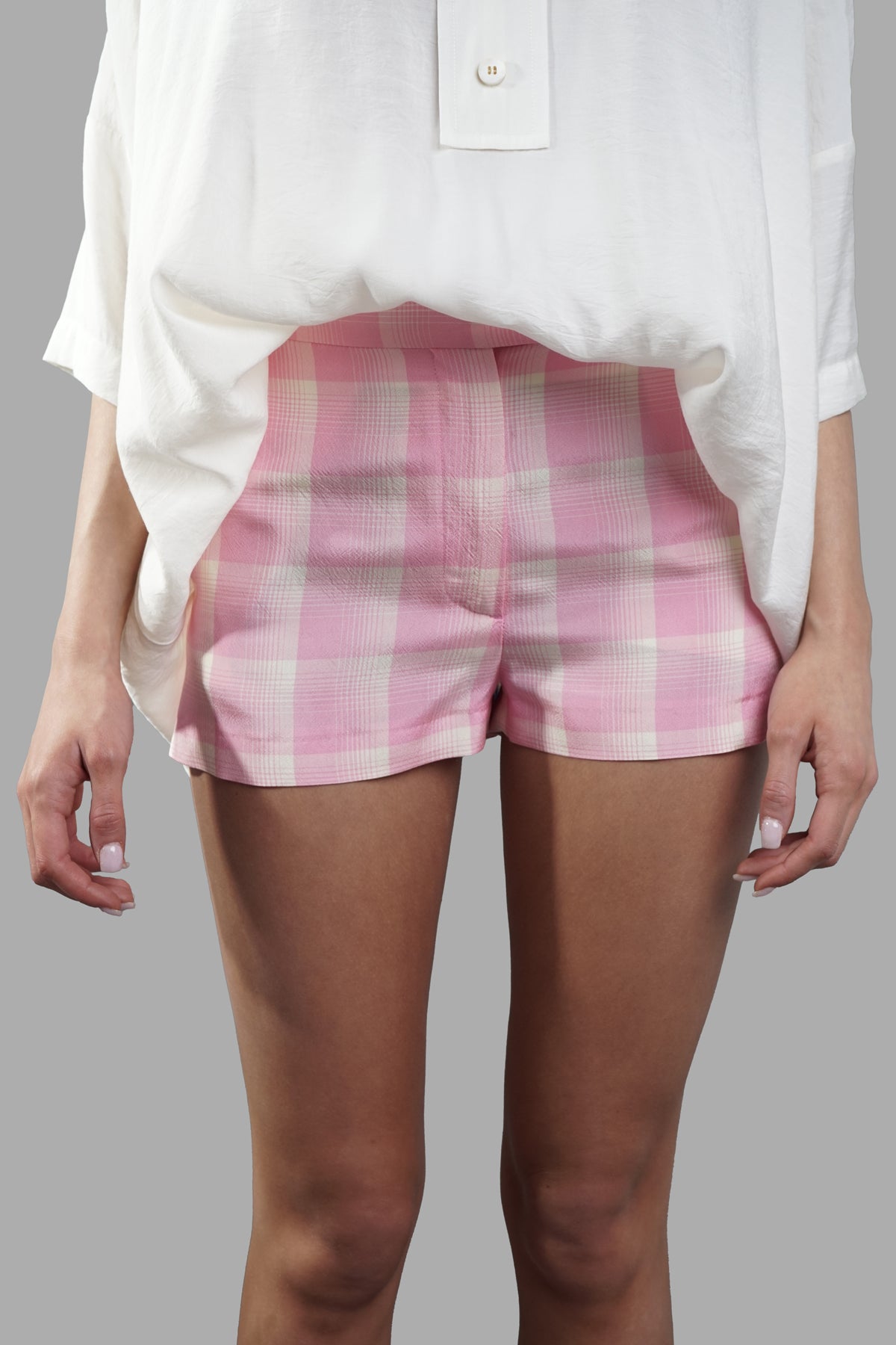 **MSGM Crepe Check Shorts in pink and white, featuring a trendy pattern and convenient pockets, modeled front view.**