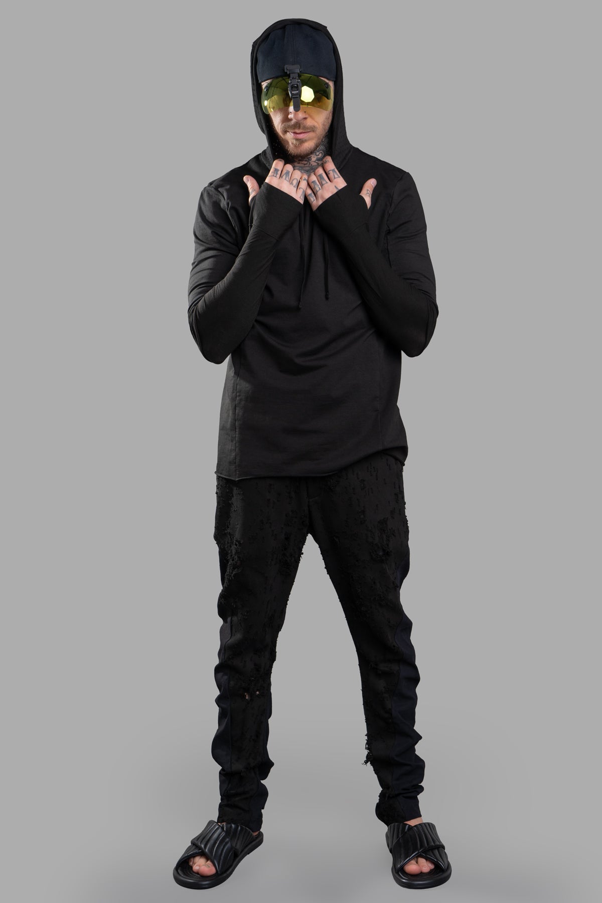 Masnada black layered hoodie, front view on model, showing unique design and narrow fit, made with soft cotton jersey.