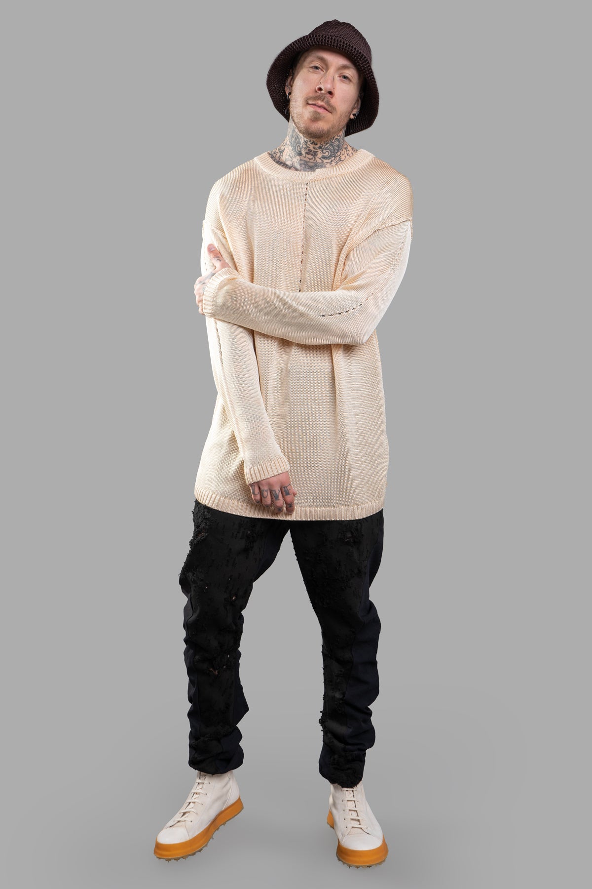 Giovanni Cavagna see-through sweater in beige, front view on model, featuring a round neckline and long sleeves.