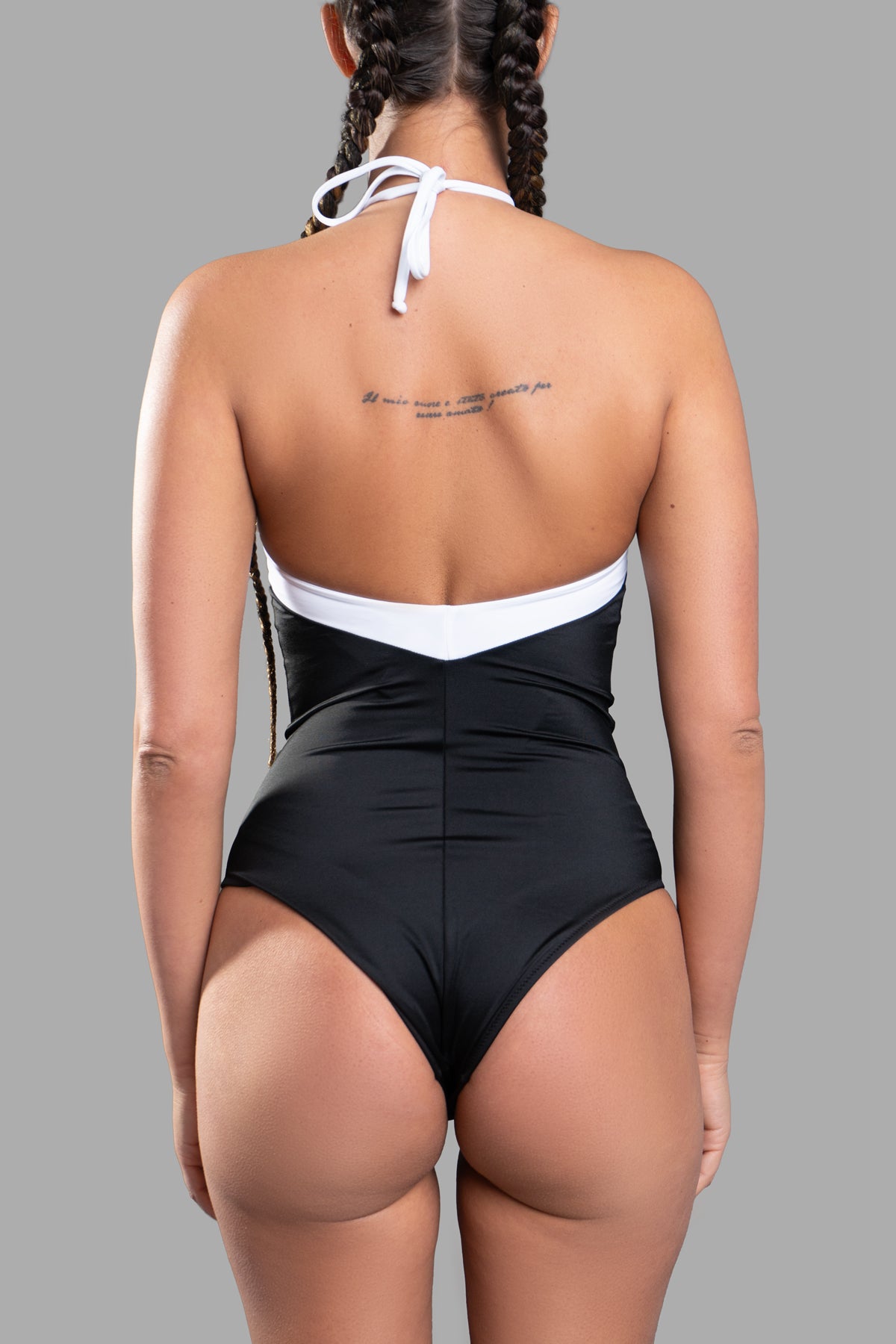 **Alt text:** Anjuna Charlie Swimsuit features a strapless design in black and white, showcasing a sleek back view.