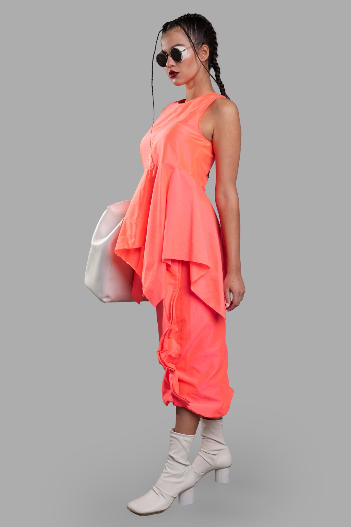 Uma Wang Frayed Peplum Top in flamingo on-model side view, showcasing sleeveless design and handkerchief hem detail.