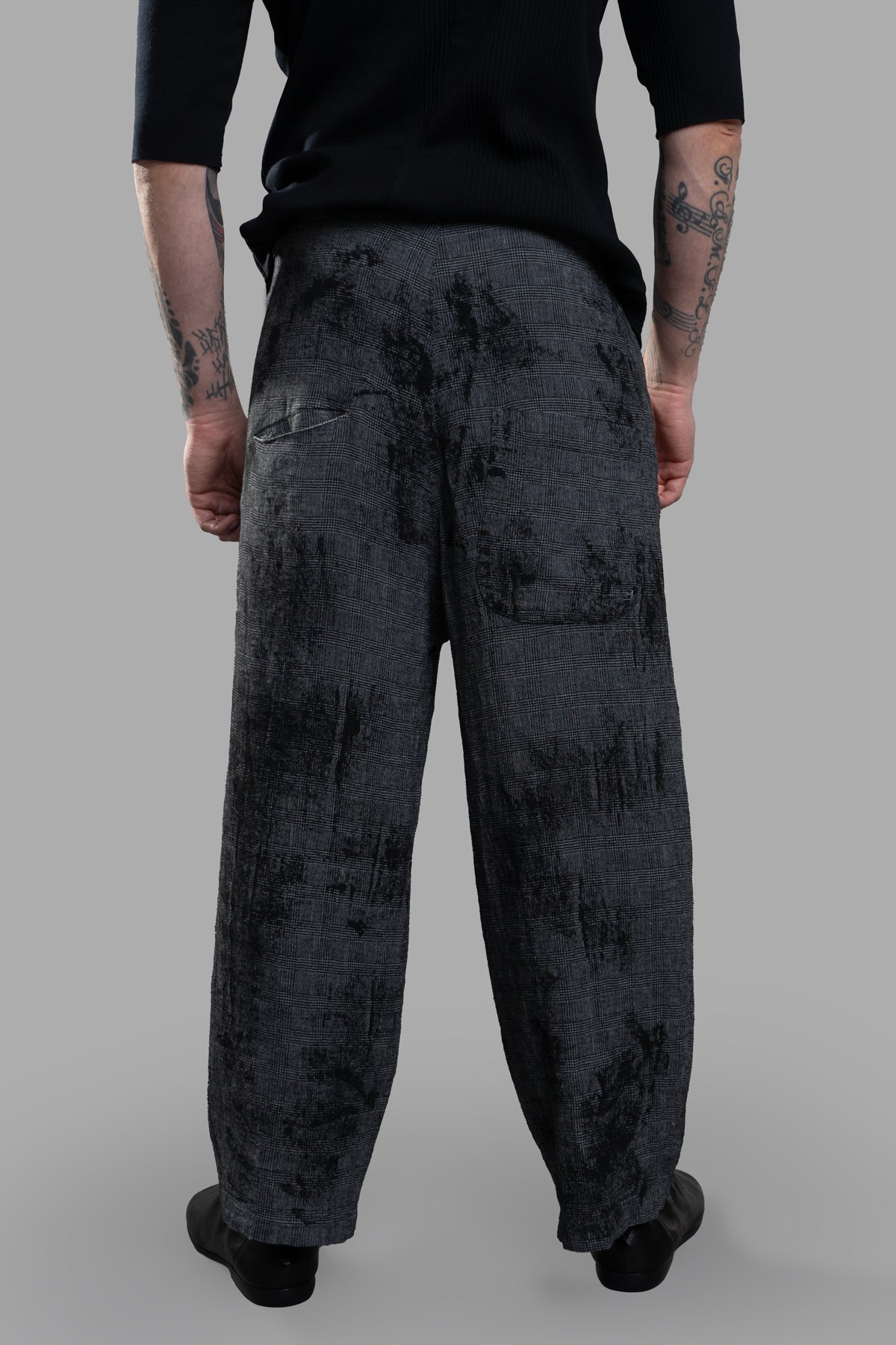 Marc Point Low Crotch Trousers displayed from the back, showcasing the relaxed fit and unique abstract pattern in grey linen.