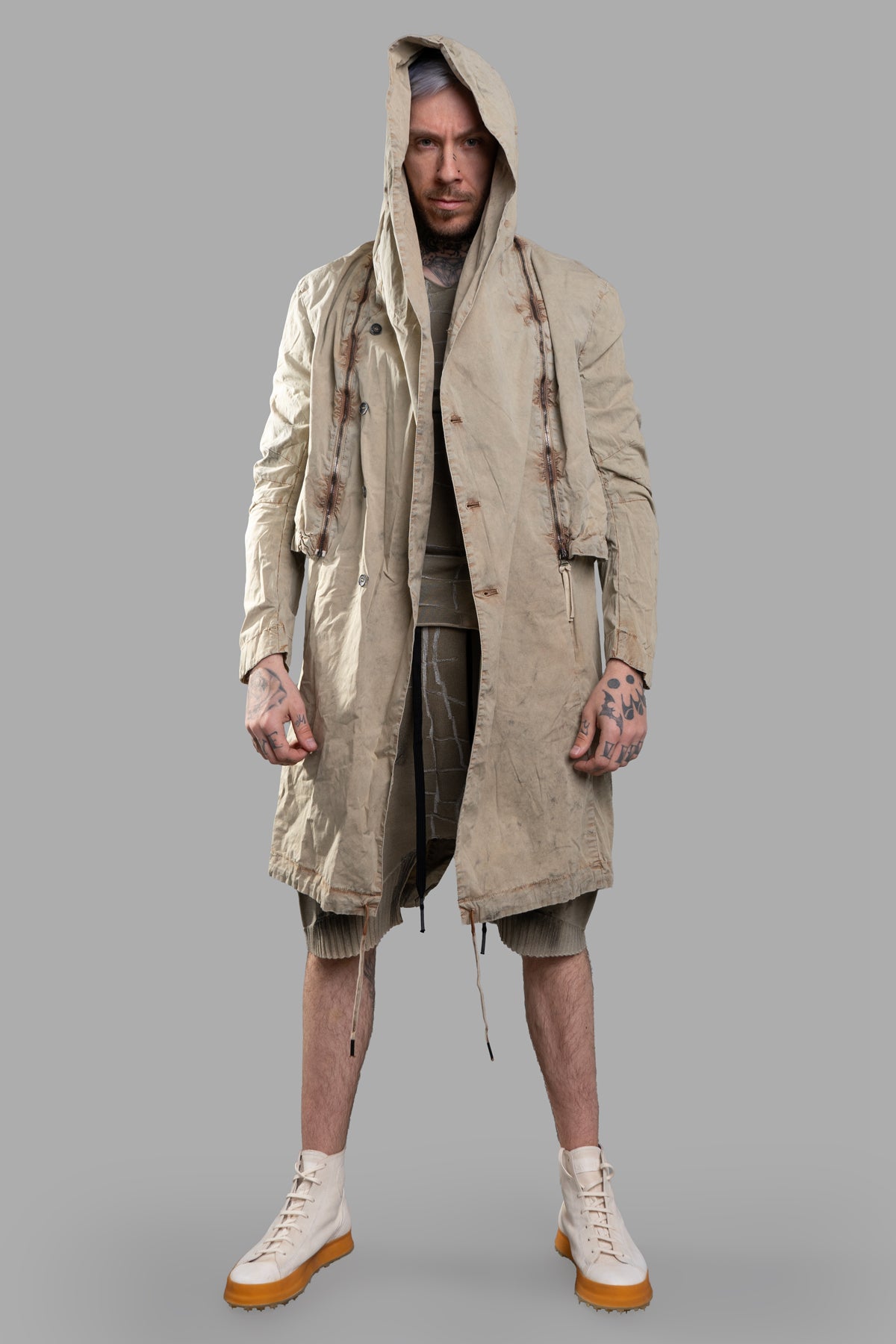 Masnada Transformative Linen Parka. Front view on model, showcasing beige mélange texture and raised seam details.