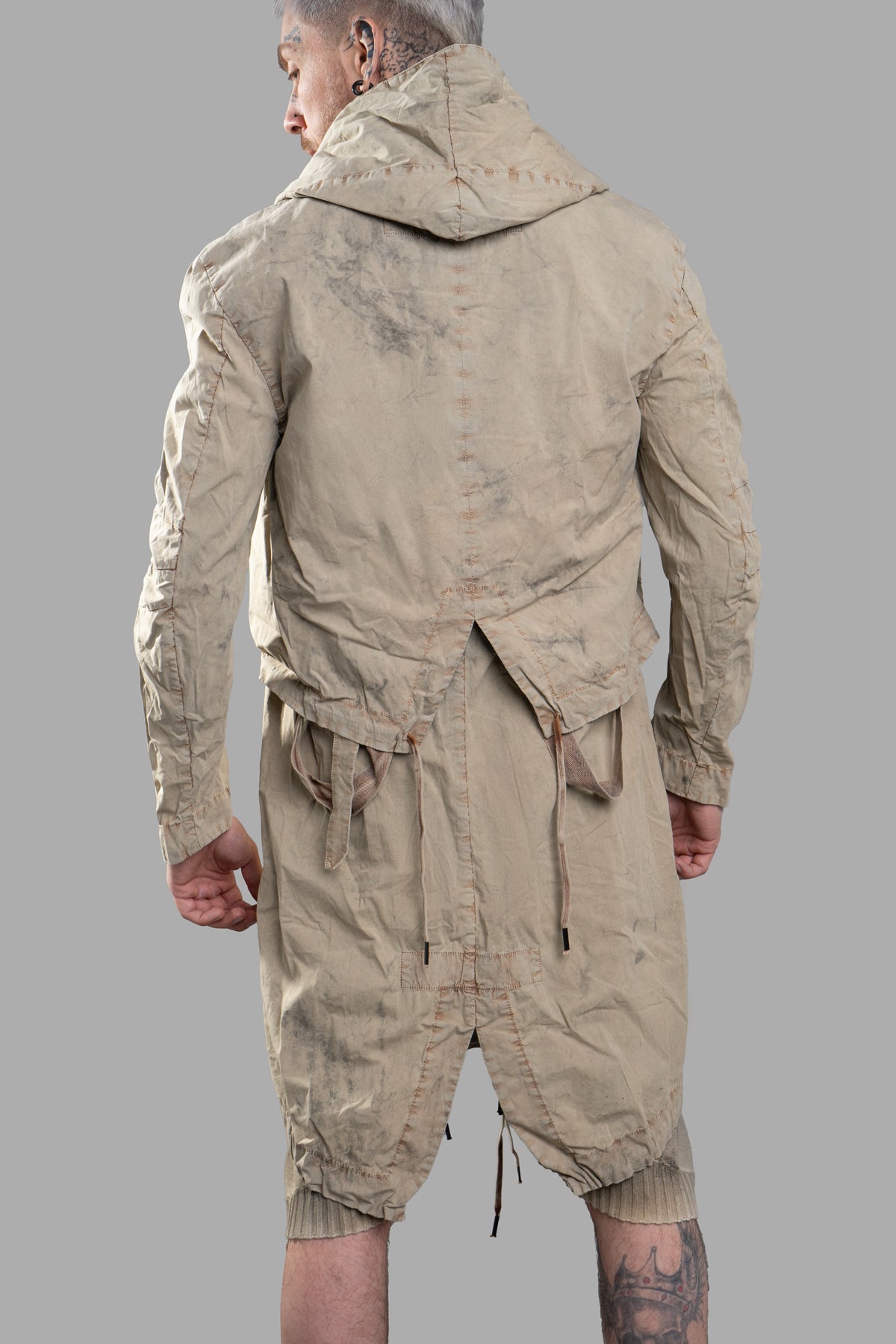 Masnada Transformative Linen Parka shown from the back, featuring a beige mélange texture and raised seams.
