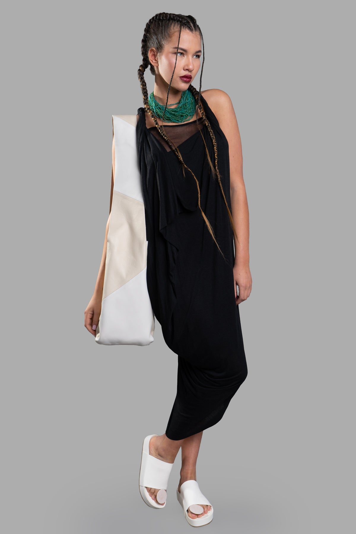 Giovanni Cavagna Asymmetric Dress, front view on model, featuring braided hair, green necklace, and white sandals.