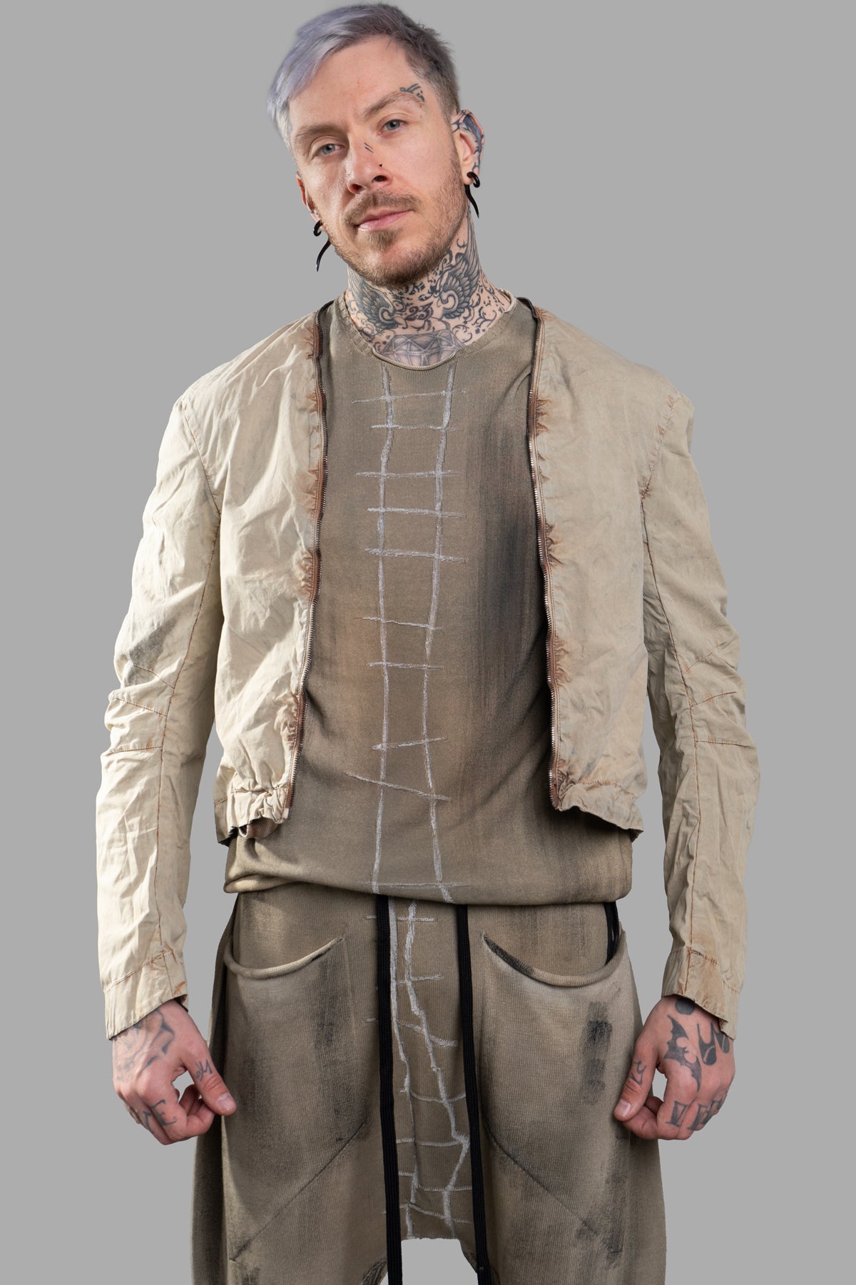 Masnada Transformative Linen Parka in beige, worn open, showcasing raised seams and luxurious texture on model.