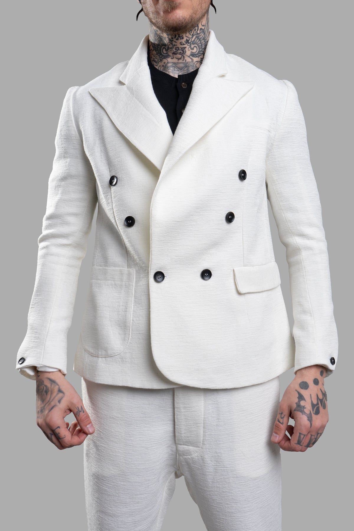 Marc Point Double-breasted Blazer in white, featuring wide peaked lapels, button cuffs, and patch pockets, showcased on-model.