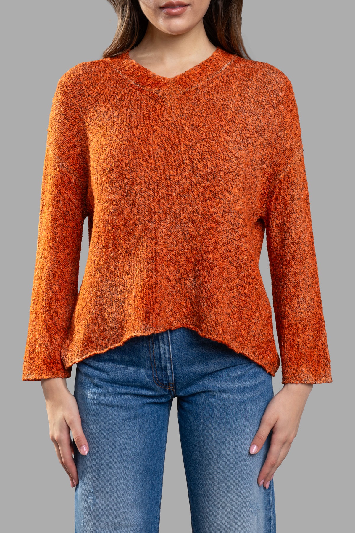 Avant Toi Orange Sweater featuring a V-neck and asymmetric hem, shown from the front on a model for a stylish look.