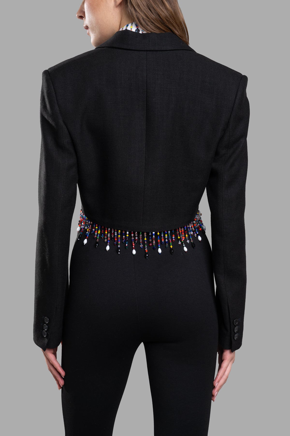 **MSGM Cropped Beaded Blazer showcasing back detail with colorful bead embellishments and fringed edge for elegant style.**