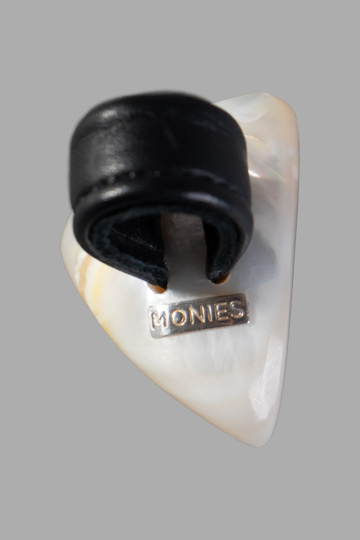 Monies Pearl Statement Ring showcases a unique mother of pearl design with a black leather strap, featuring logo detail.