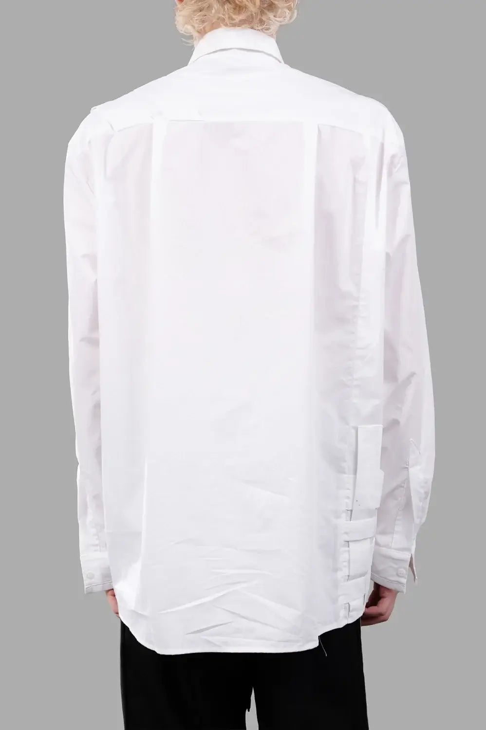 Back close-up of white shirt with clean yoke and long sleeves, minimal detailing