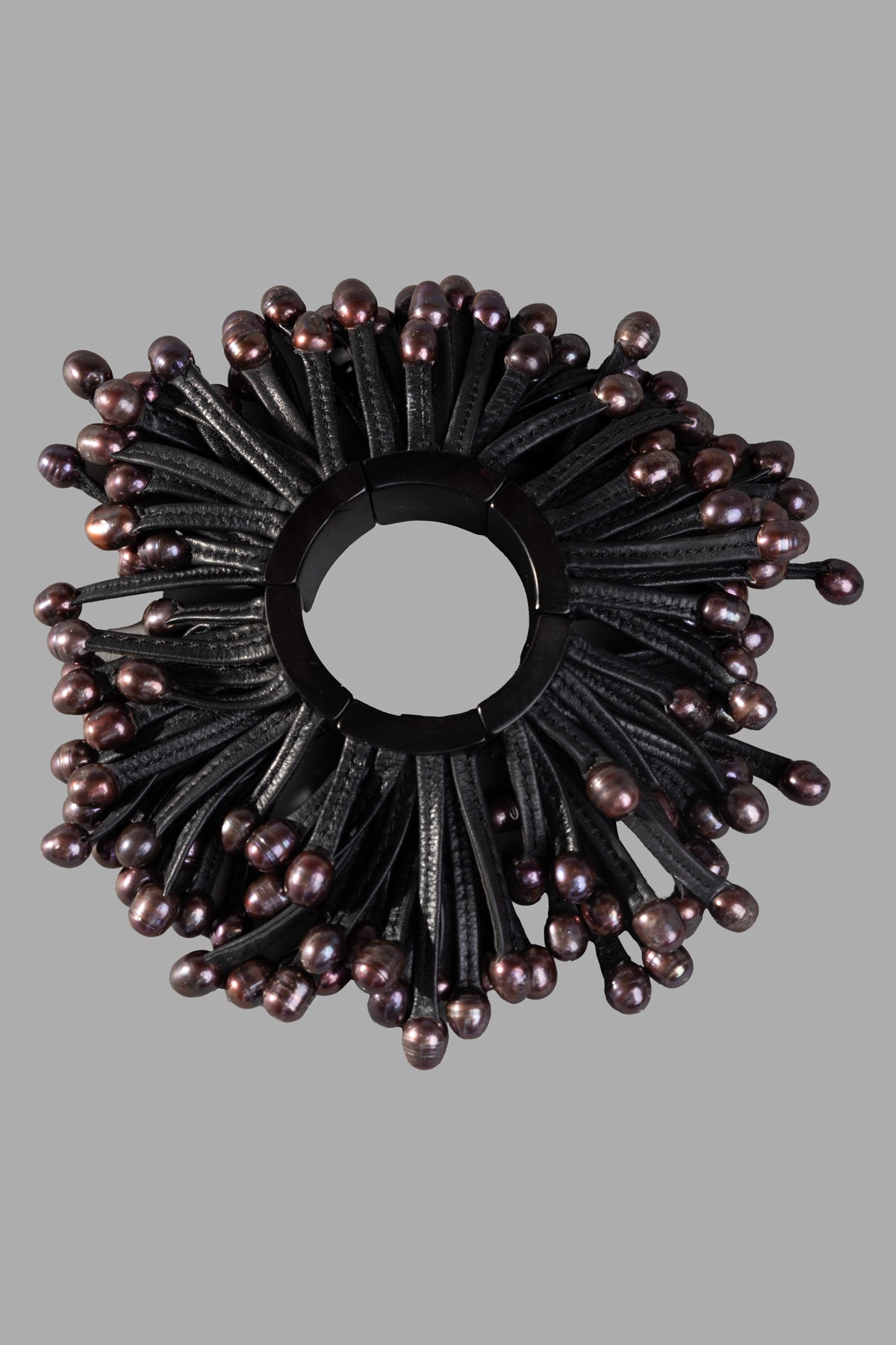 Monies Beaded Bracelet front view showcasing black leather strands with dark beads on a gray background.