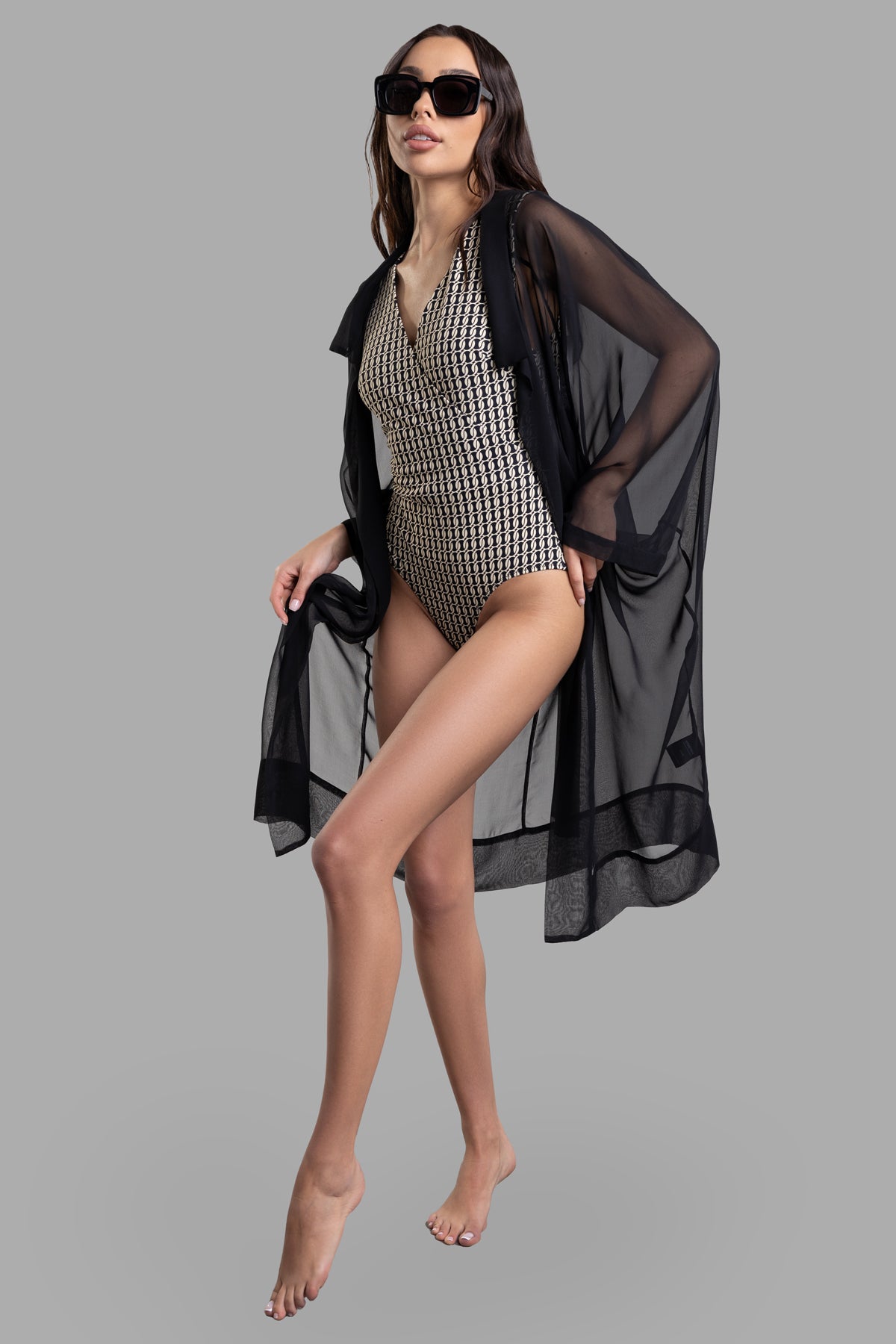 By Malene Birger Lemooria Swimsuit in bold pattern, front view, styled with black sheer cover-up, on-model.