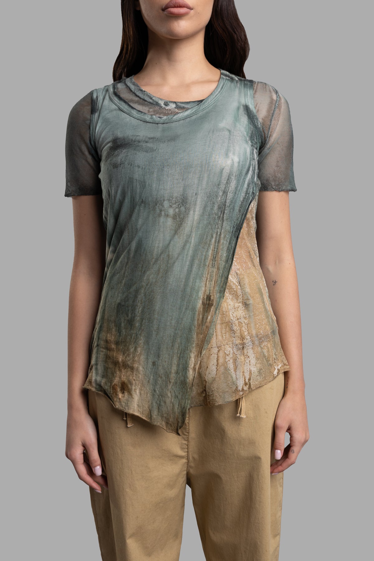 Masnada Layered T-shirt features a breathable mesh bottom and stylish asymmetric cotton top, shown on model from the front.