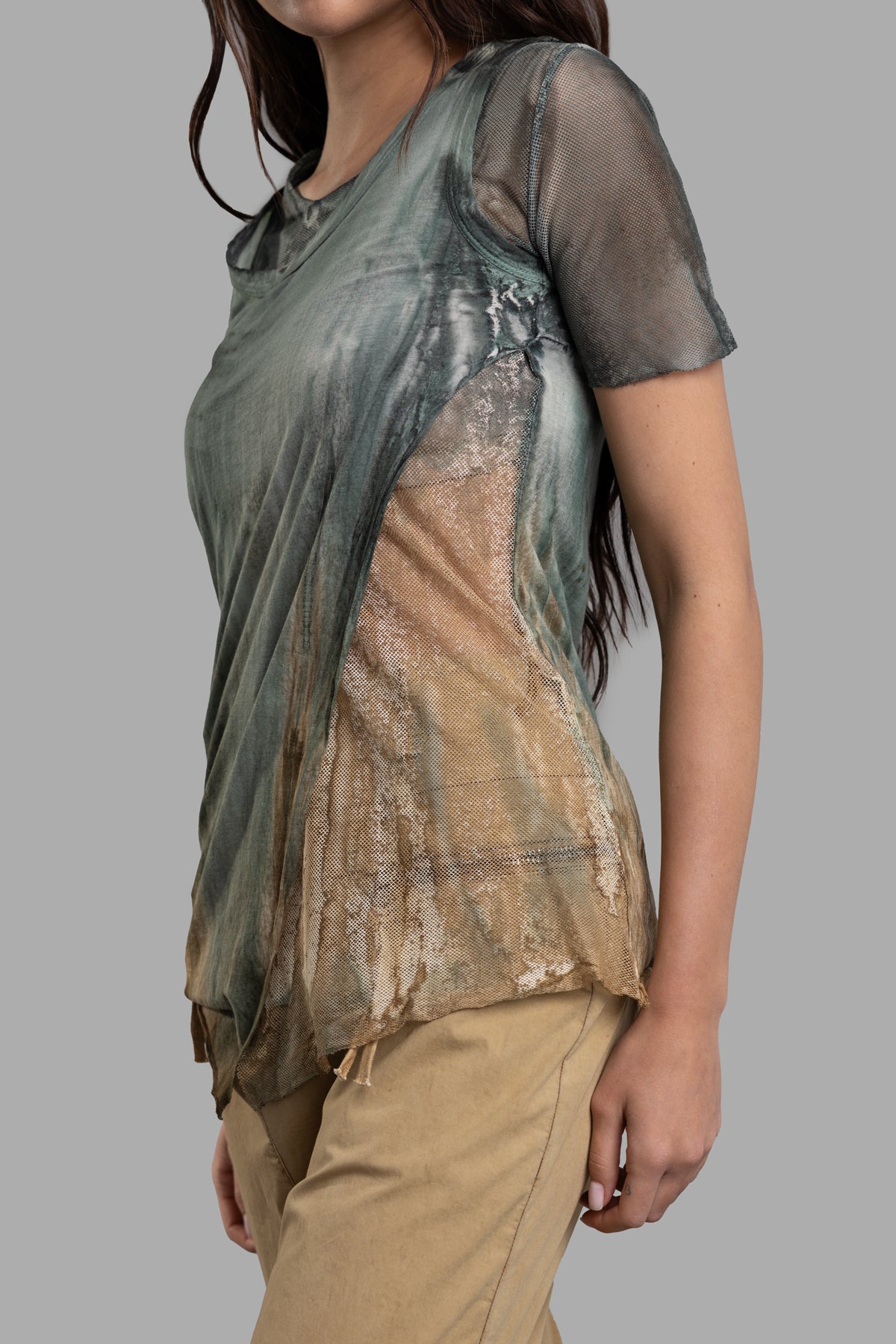Masnada Layered T-shirt features a stylish asymmetric design with mesh detailing, shown from the side on a model.
