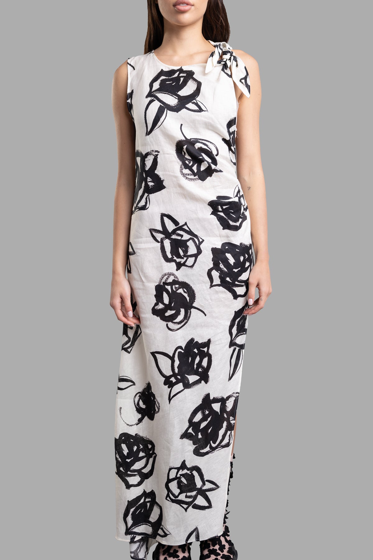 MSGM Rose-print Maxi Dress displayed on model, featuring delicate black rose print on slub linen, sleeveless with a side.