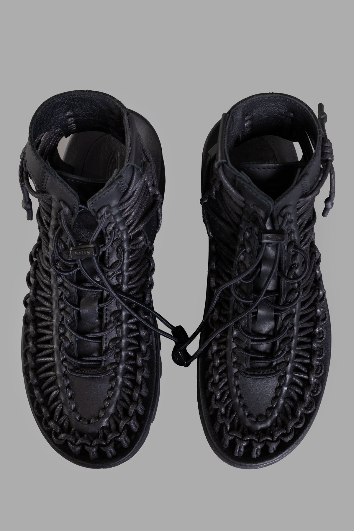 Noir Kei Ninomiya Caged Platform Shoes, top view showcasing intricate lacing and sleek black leather details.