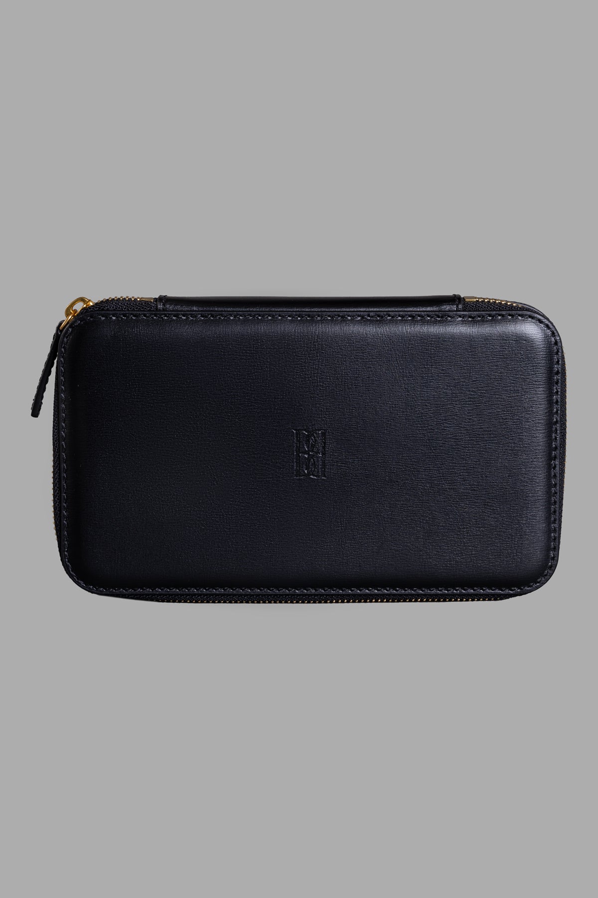 By Malene Birger Leather Beauty Case in black, showcasing front view, monogram detail, and sleek recycled leather finish.