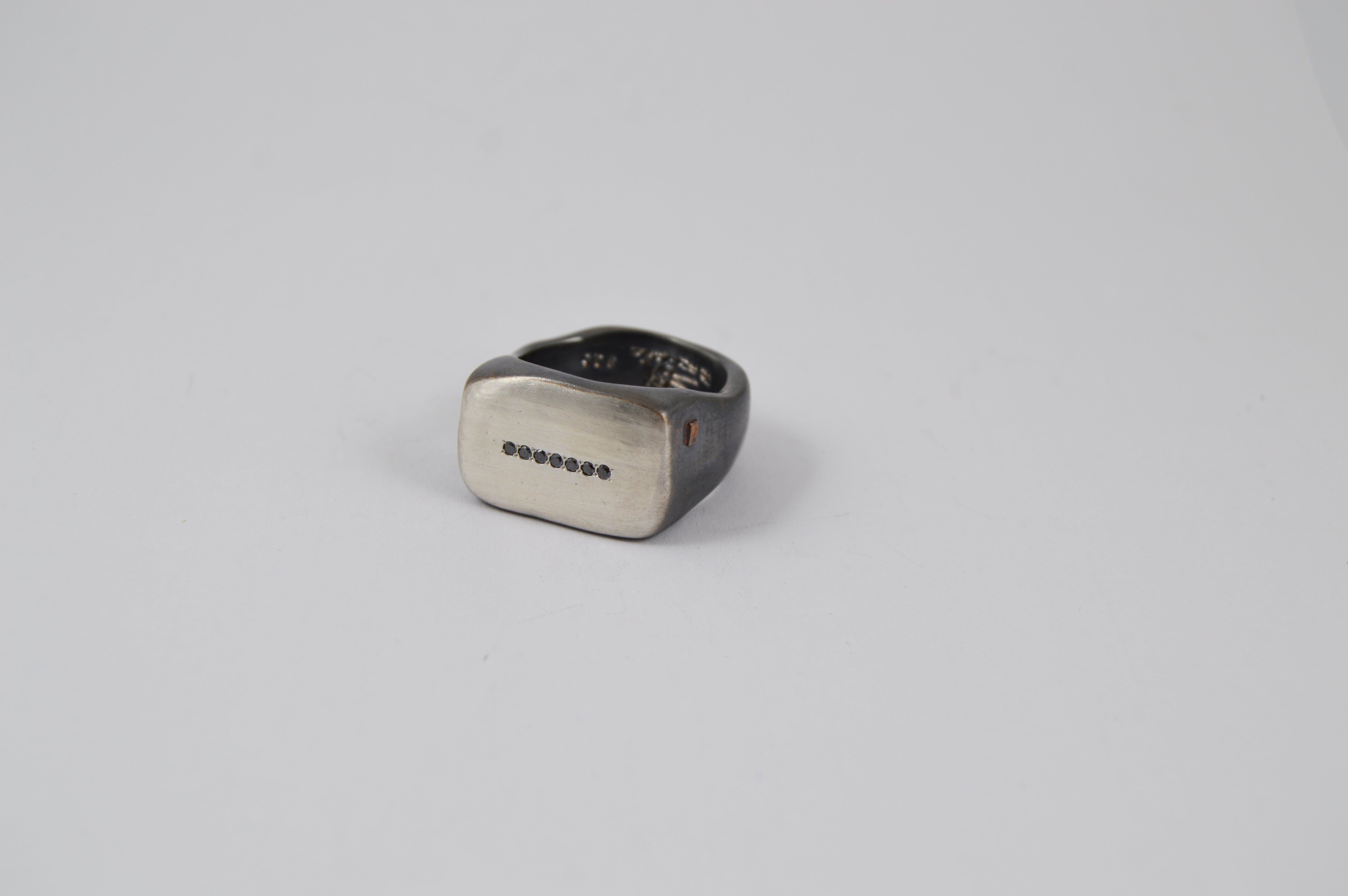 Rosa Maria Lulu Ring, close-up of silver band featuring a raw organic design with black diamonds, showcasing handcrafted.