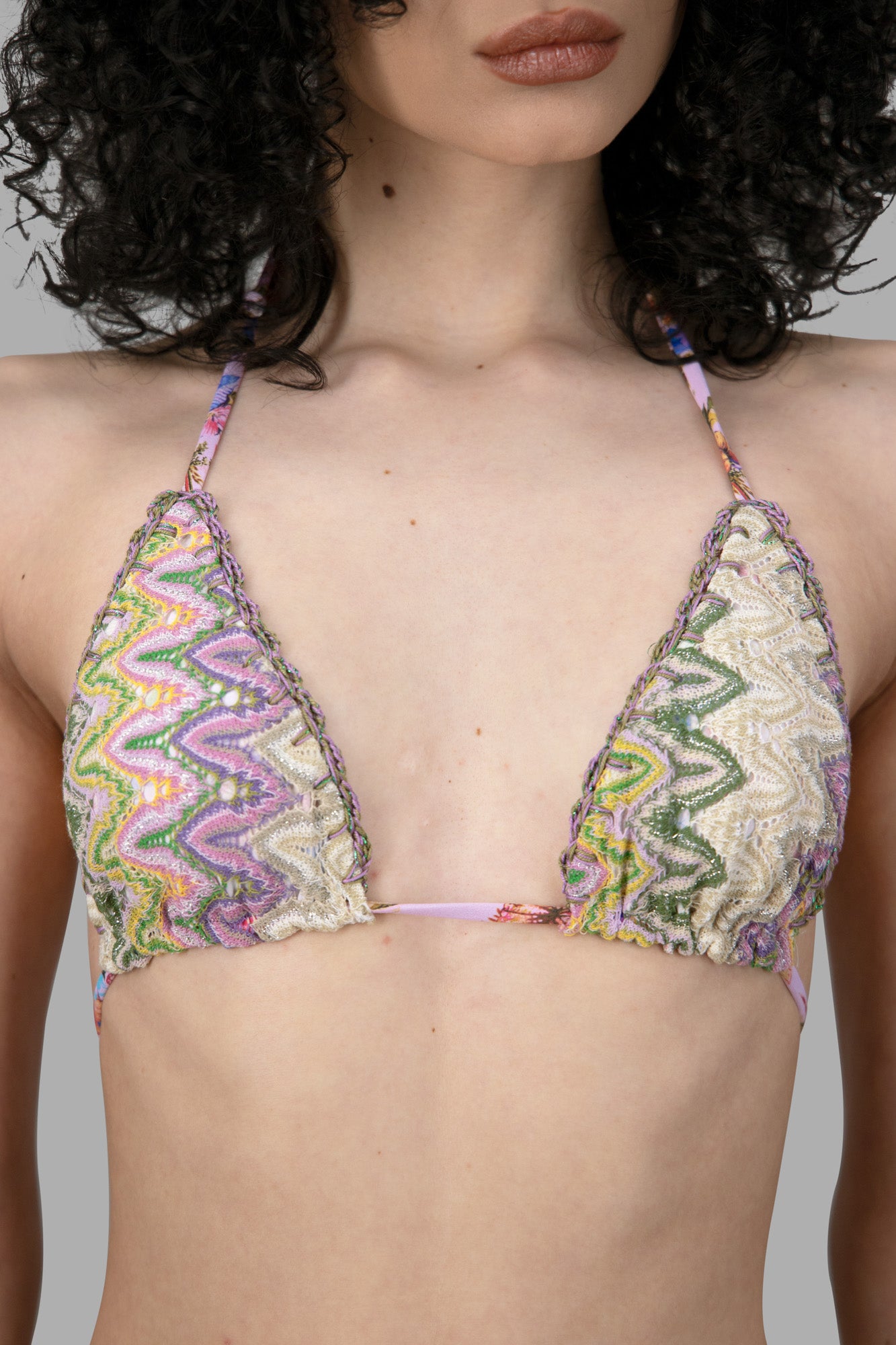 Anjuna Reversible Crochet Bikini featuring a colorful chevron pattern in a close-up view of the triangle cup top.