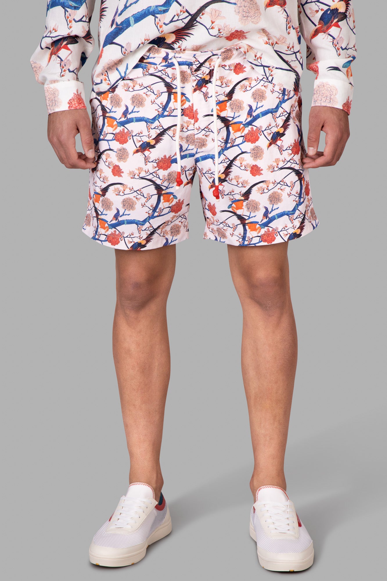 Orlebar Brown Mid-Length Swim Shorts featuring a vibrant rose print, shown front view on model, crafted from 100% recycled.