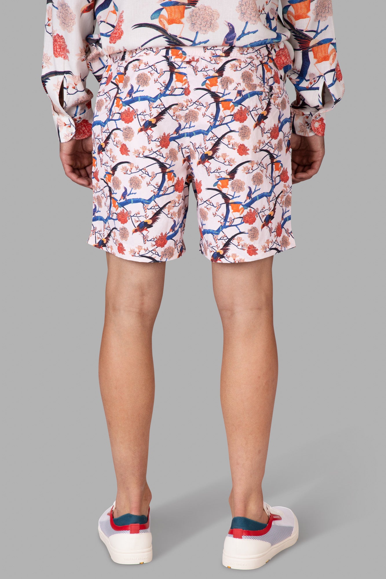 Orlebar Brown Mid-Length Swim Shorts in vibrant rose print, showcasing floral design from the back on a model.