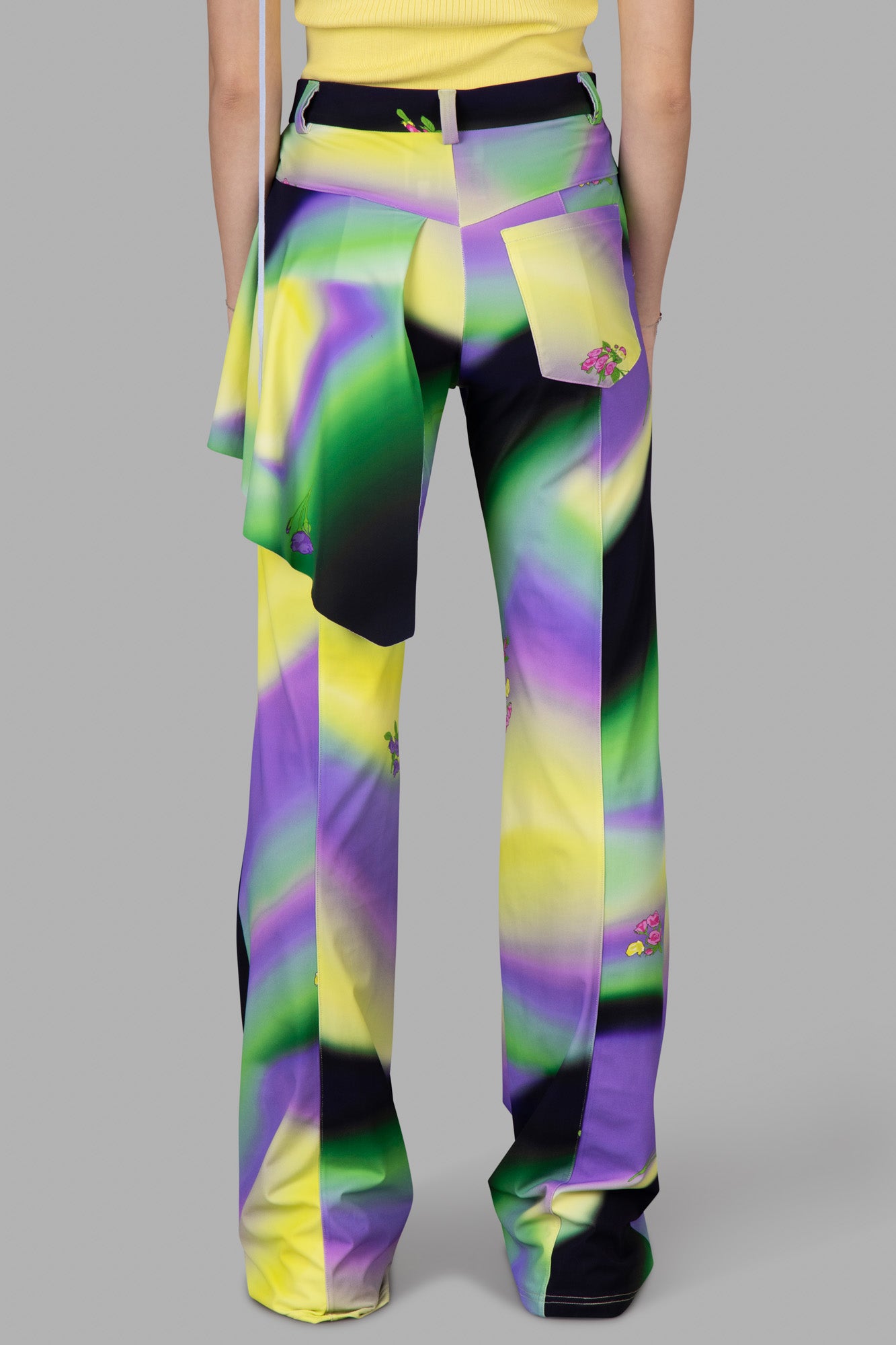 Natasha Zinko Ombré Print Trousers feature a multicolor pattern, peplum waist, and subtle floral details on the back.