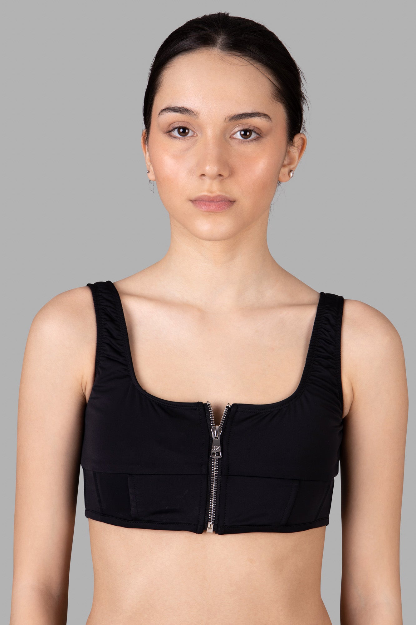**Alt Text:** Natasha Zinko black corset-style bikini top featuring a scoop neck, structured bodice, and rear zip for a tailored look.