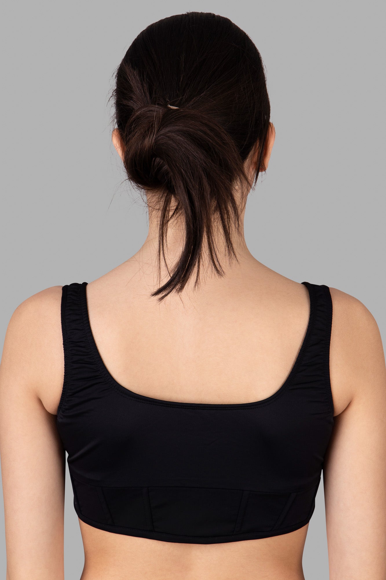 **Alt text:** Natasha Zinko Corset-style Bikini Top with a scoop back, featuring a fitted design and smooth stretch fabric in black.