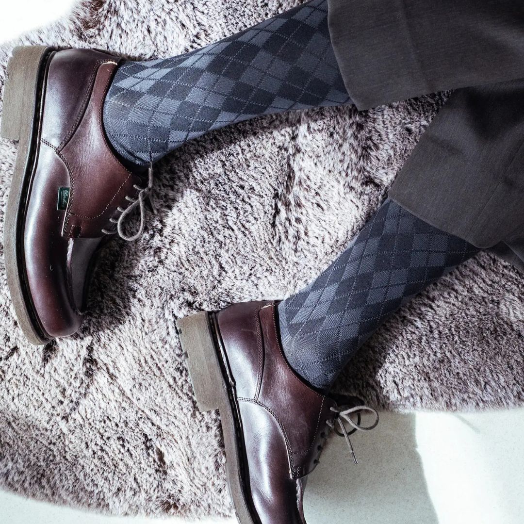 Tabio. Supima Cotton Diamond Crew Socks on a model, showcasing a navy/grey diamond pattern paired with brown shoes.