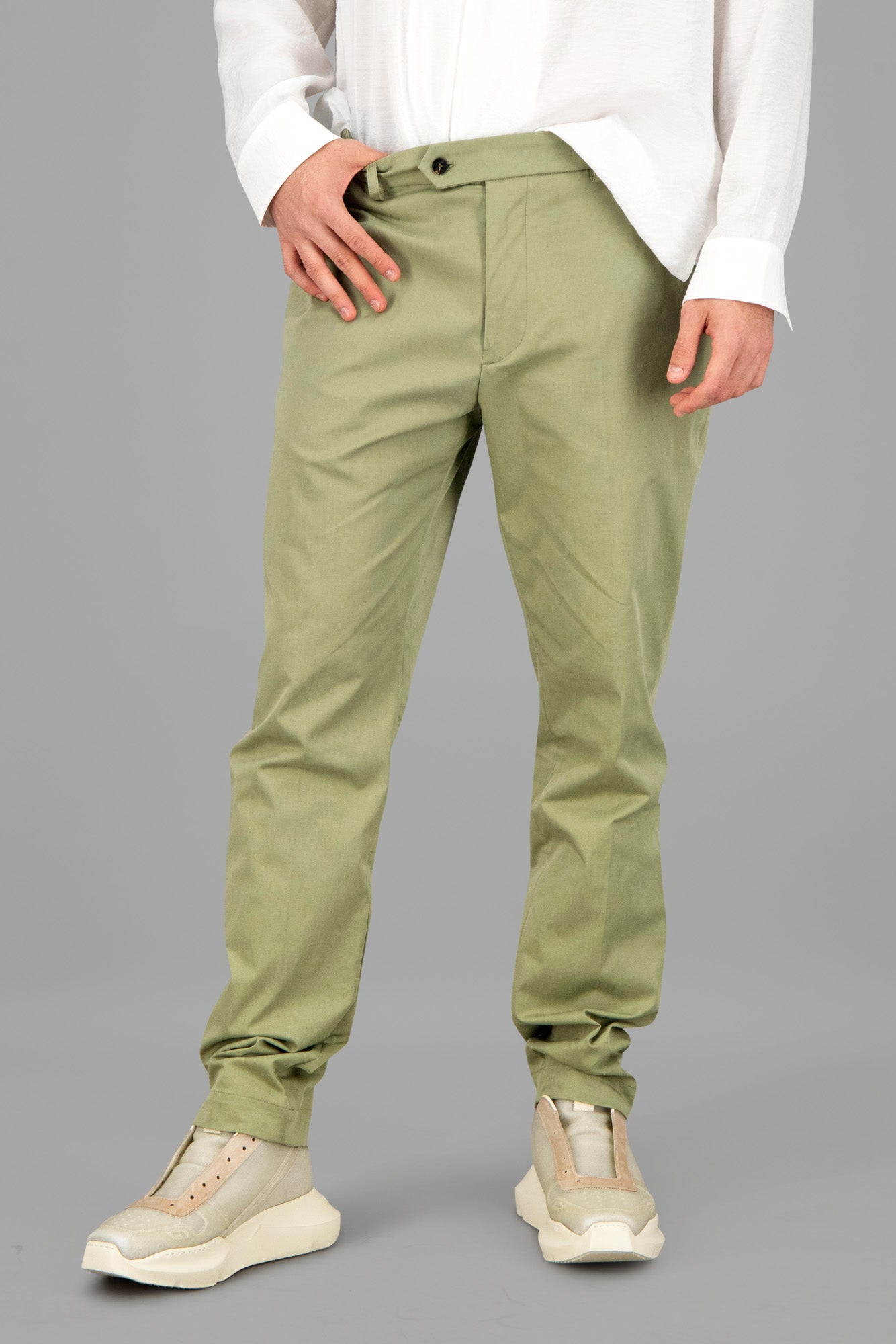 AION. Olive Green Straight-Leg Trousers showcased on model, featuring an elastic waistband and zip fastening for comfort.