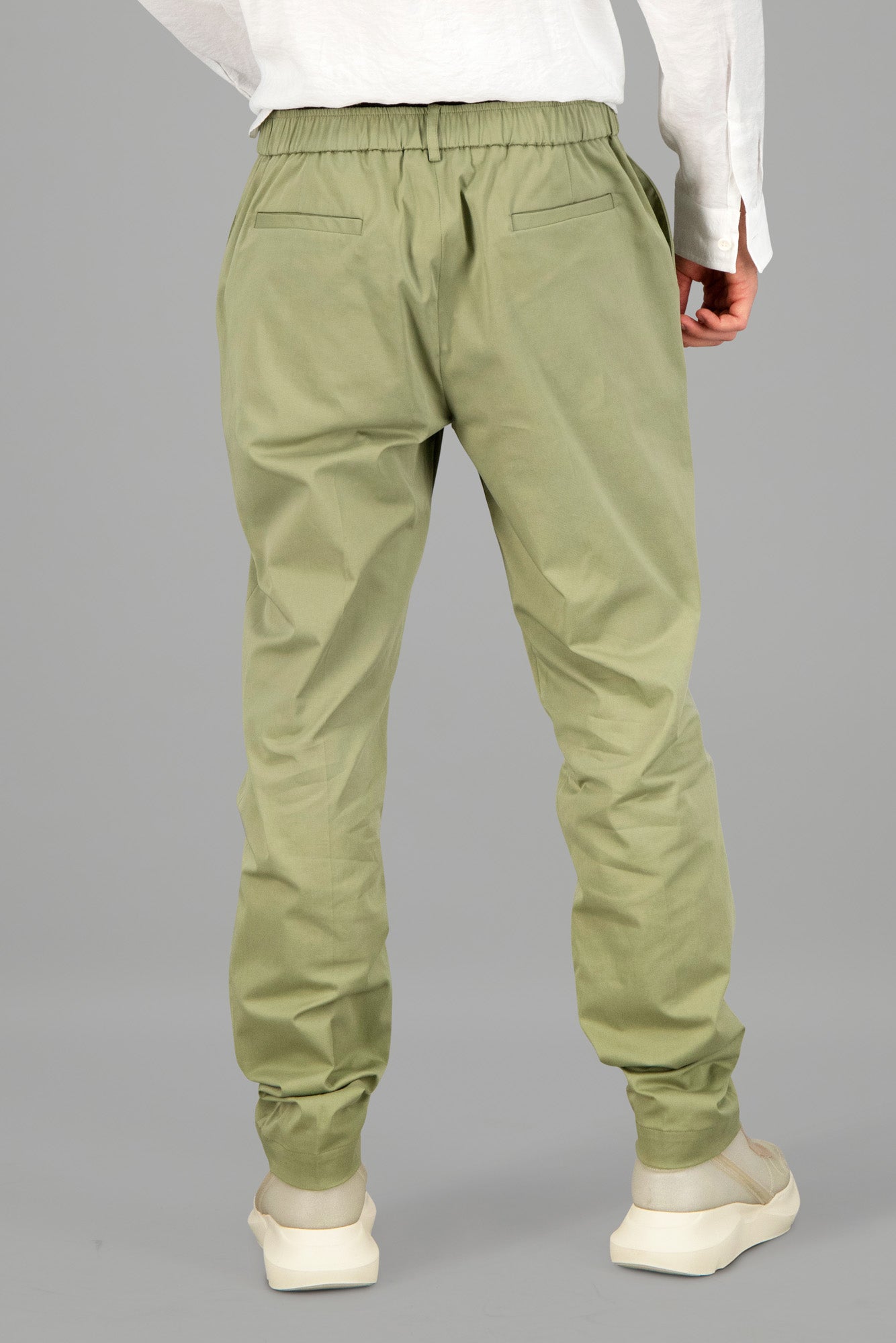 AION Olive Green Straight-Leg Trousers showcasing elasticated waistband and back details, presented on a model's rear view.