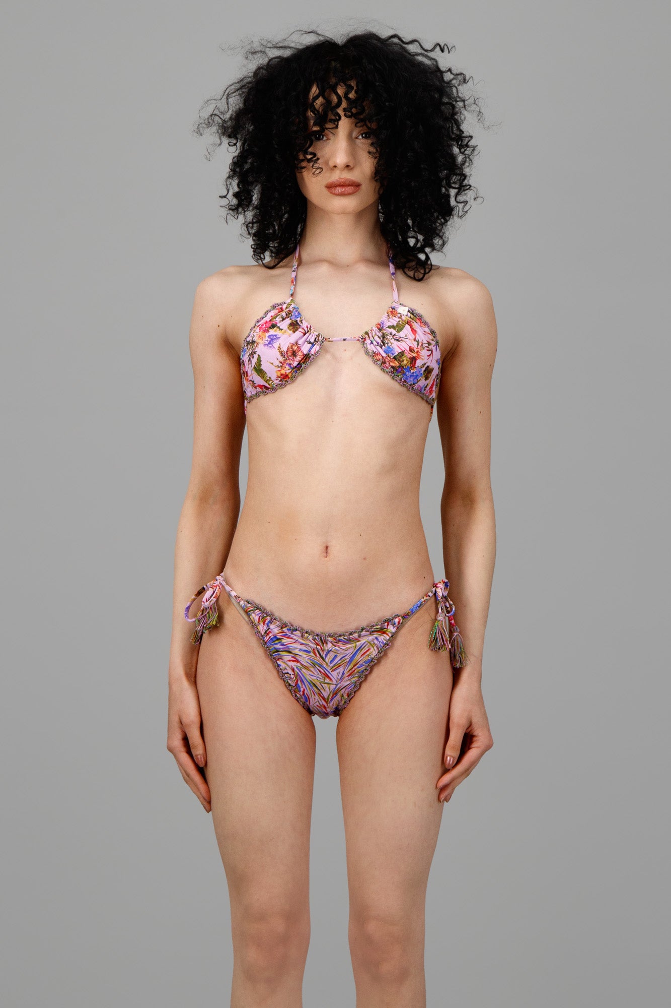 Anjuna Reversible Crochet Bikini featuring floral print and chevron design, model wears bikini top and side-tie bottom.