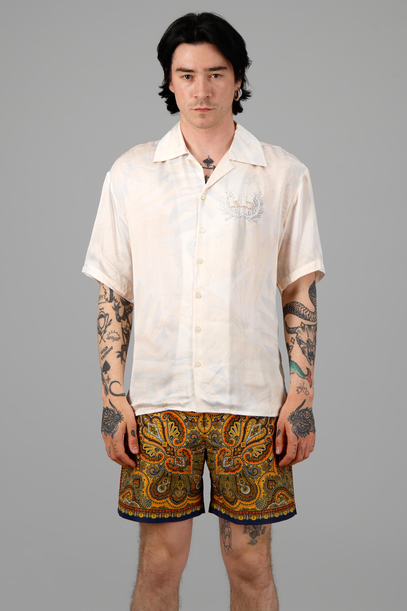 Orlebar Brown Mystique Print Swim Shorts on model, featuring vibrant paisley pattern and contrasting hem design.