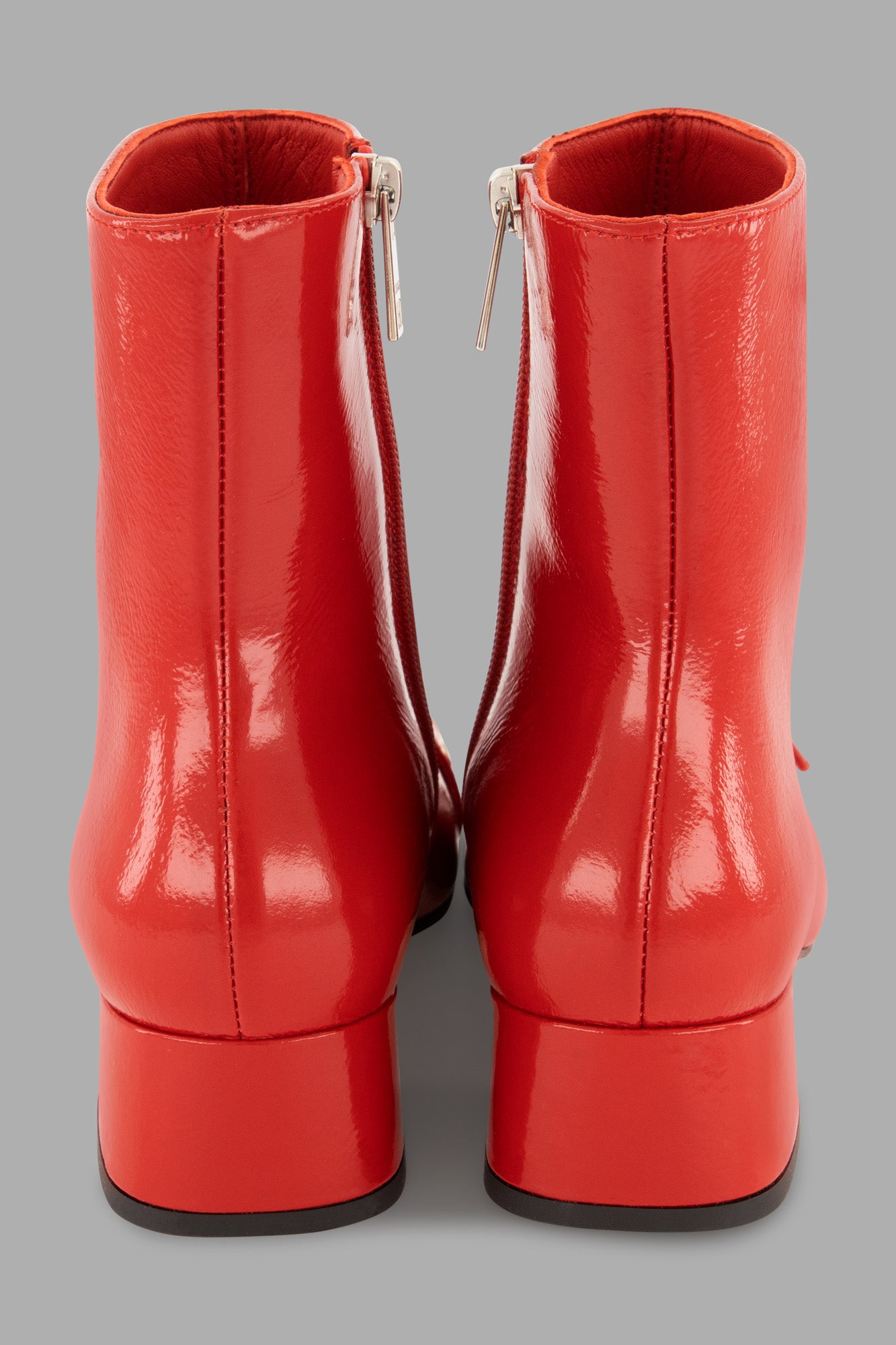 MSGM Latex Boots in red, showcasing a zip-up back and glossy finish, perfect for fall-winter style.