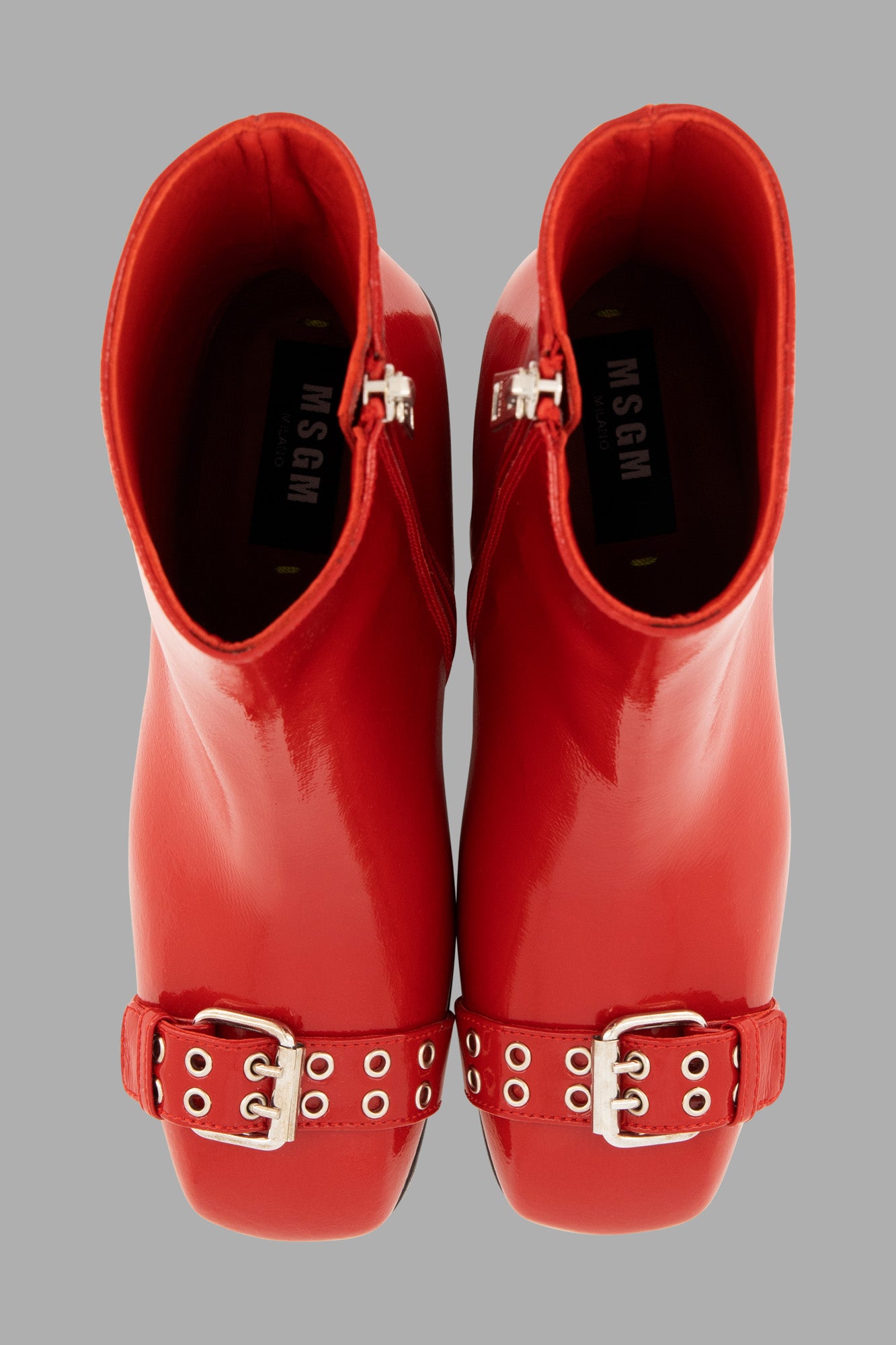 MSGM Latex Boots in vibrant red, showcasing a buckle detail and side zip fastening from a top-down view.