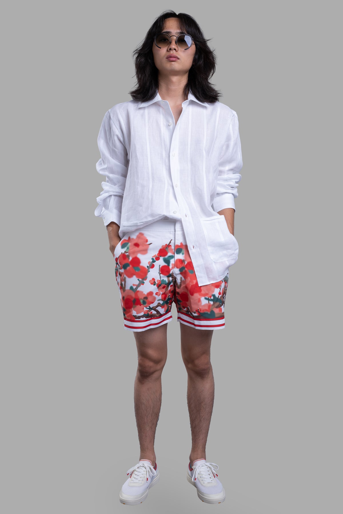 Orlebar Brown Resort Overshirt in white linen, worn on-model with floral shorts, front view showing modern collar and.